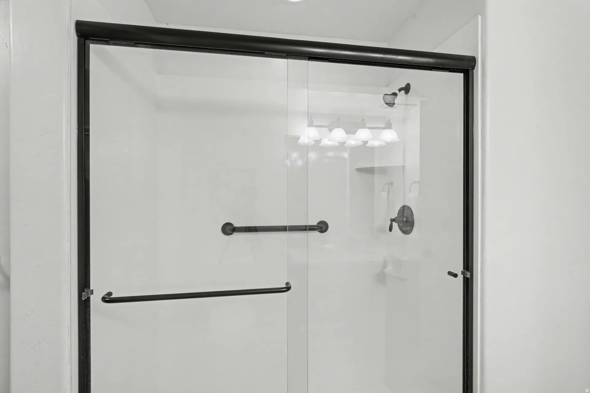 Full bathroom featuring a shower stall