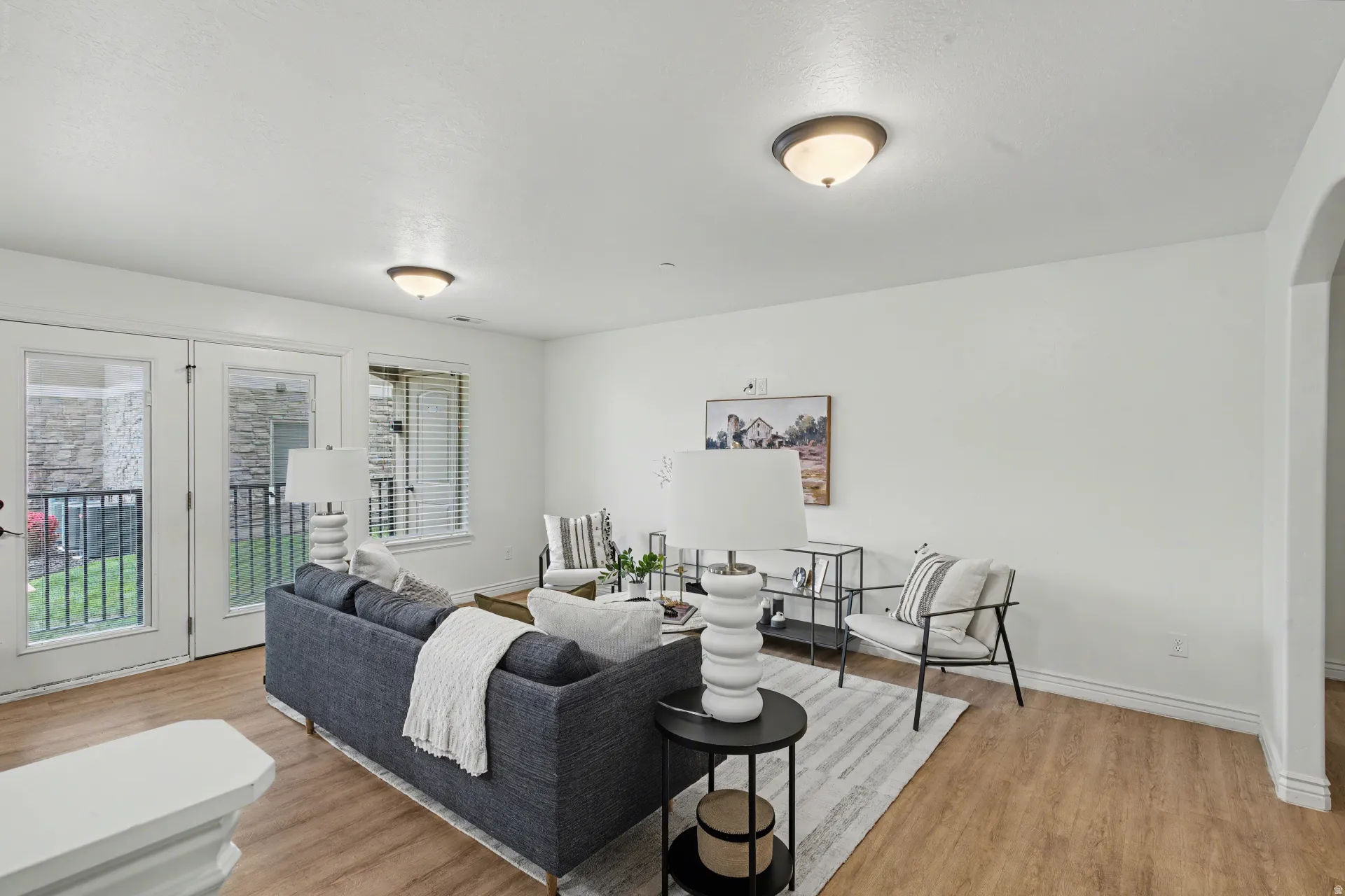 Living area featuring light wood-type flooring and baseboards