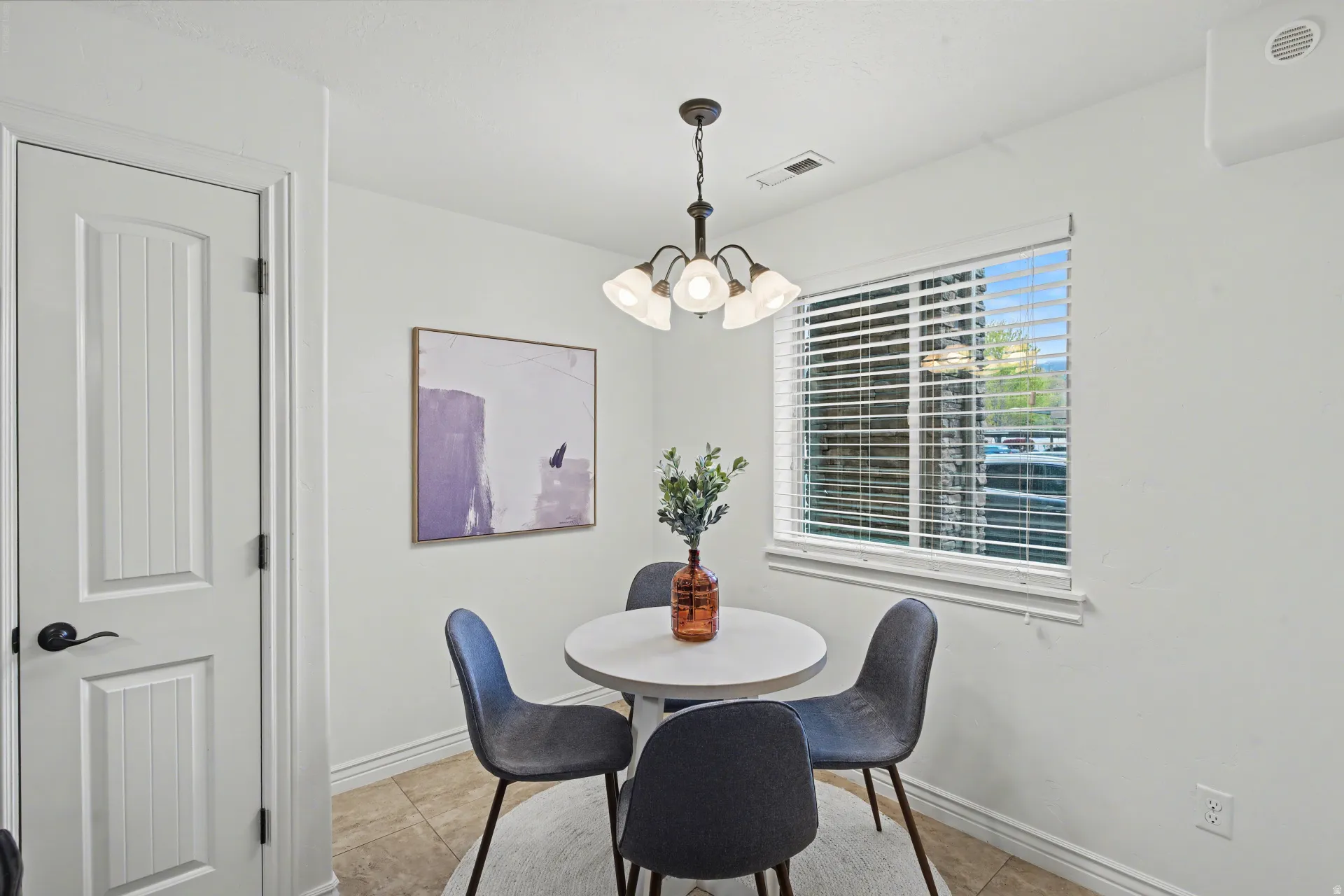 Dining area featuring a chandelier and light tile patterned floors
