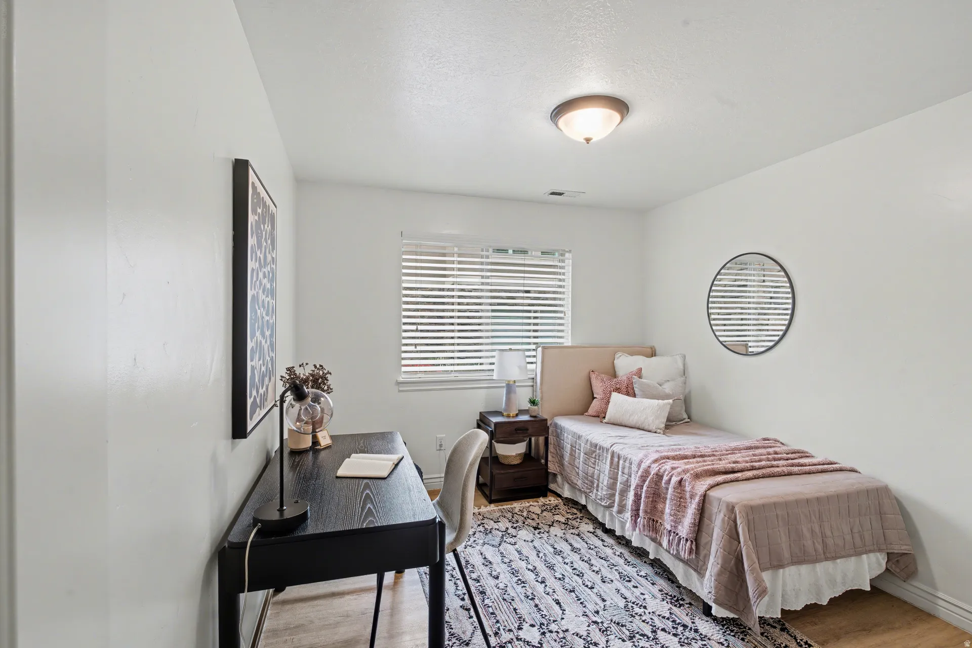 Bedroom with light wood-style floors