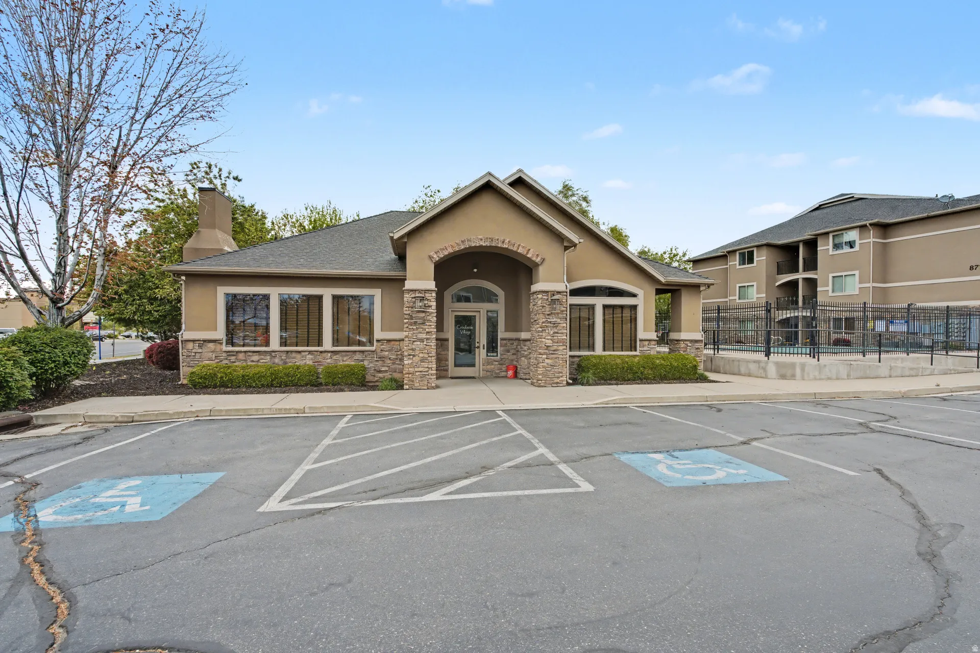 View of building exterior with uncovered parking