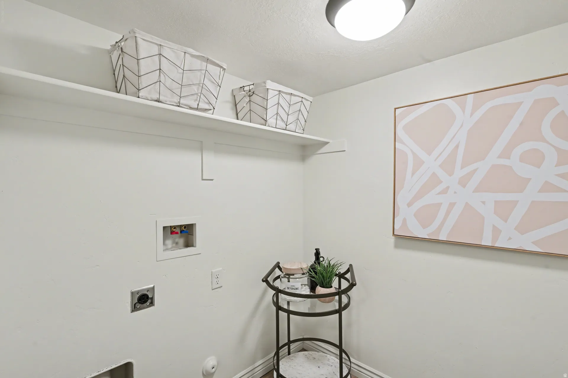 Laundry area featuring hookup for a washing machine, hookup for an electric dryer, and a textured ceiling