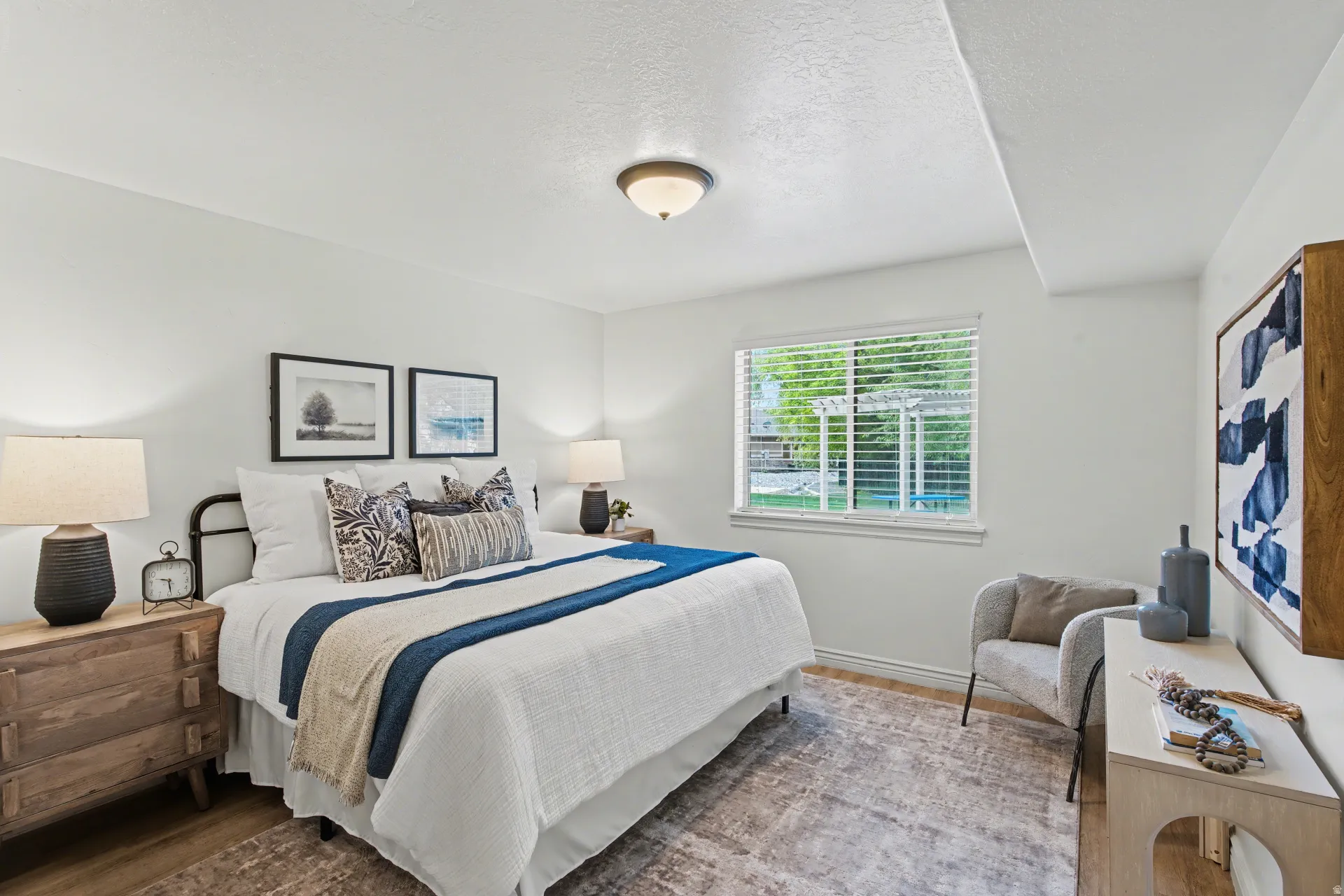 Bedroom with wood finished floors and a textured ceiling