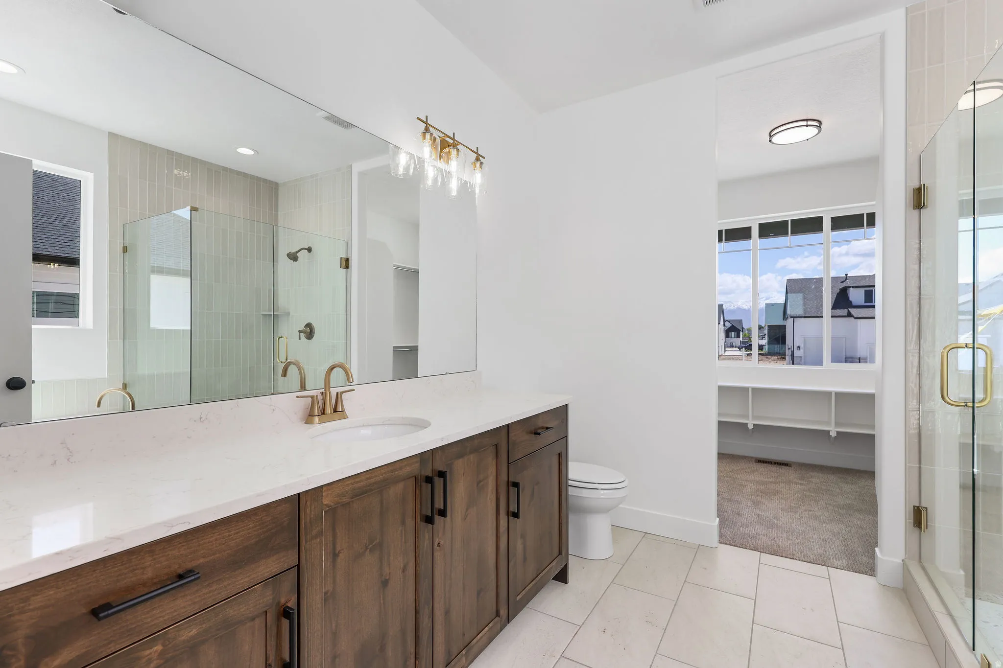 Bathroom featuring a wide vanity with a light-toned countertop, a full-width mirror, and a rectangular under-mount sink