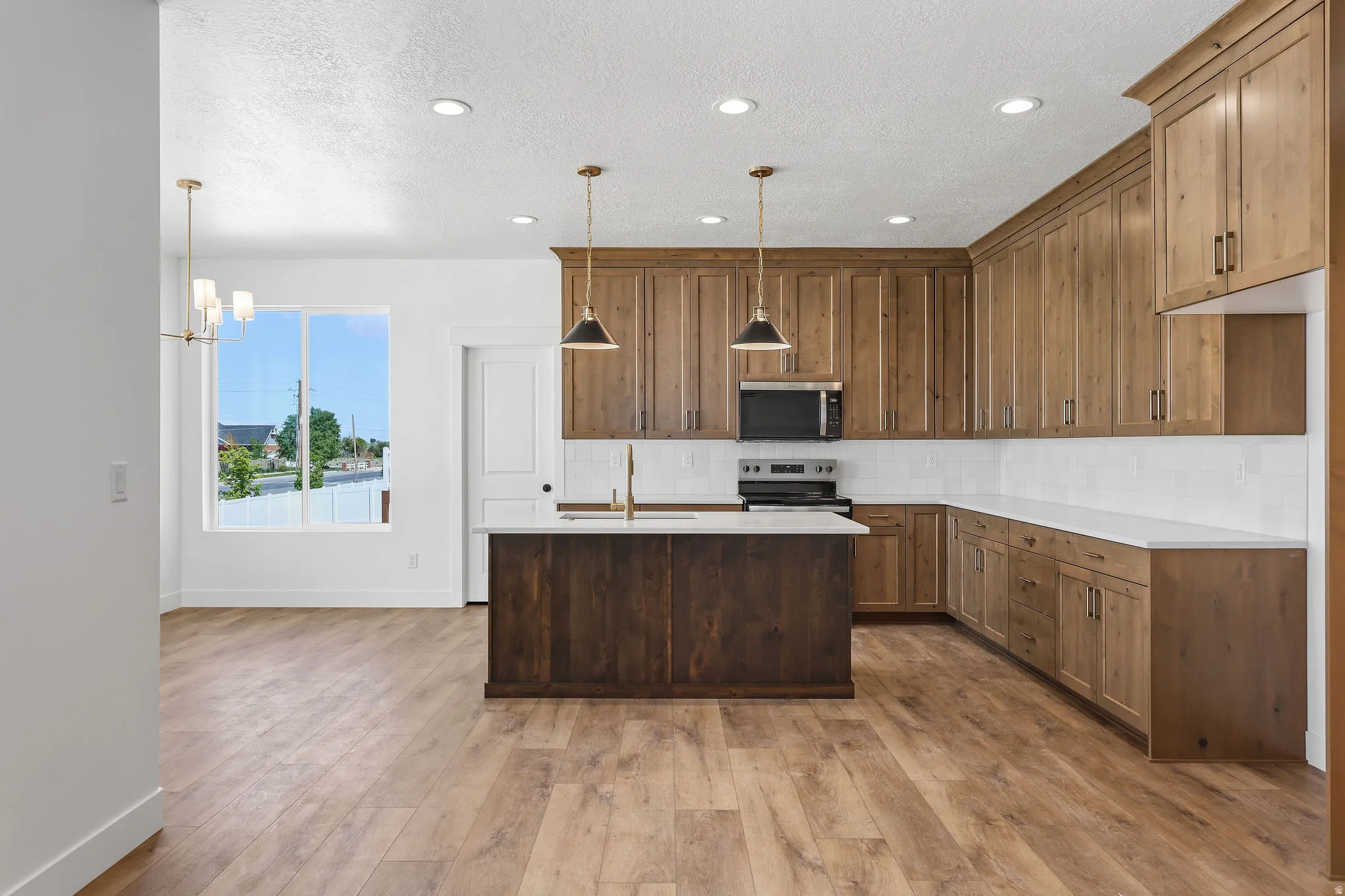 Kitchen featuring wood-finish flooring, recessed lighting, and a window with natural light