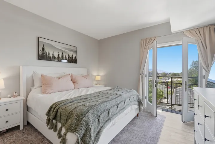Bedroom with access to outside and light wood-style floors
