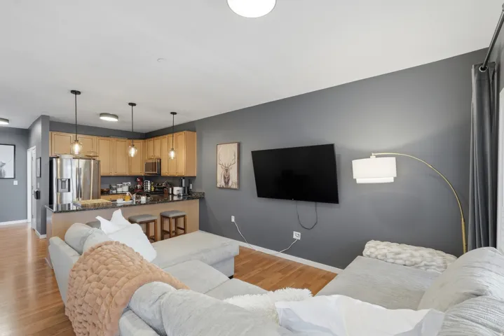 Living area featuring light wood-type flooring and baseboards