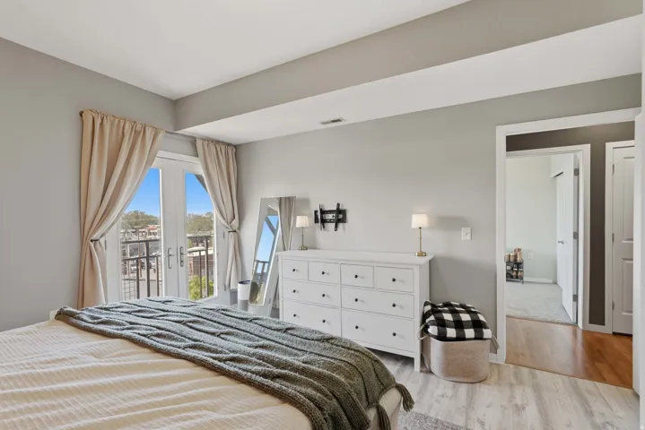 Bedroom featuring access to outside, light wood-style flooring, and french doors