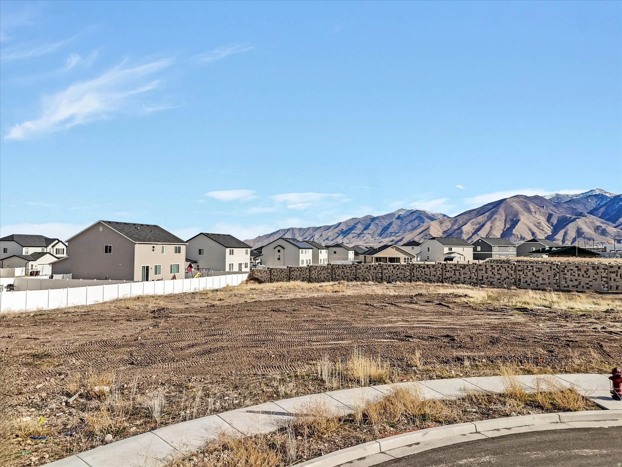 View of mountain backdrop featuring nearby suburban area