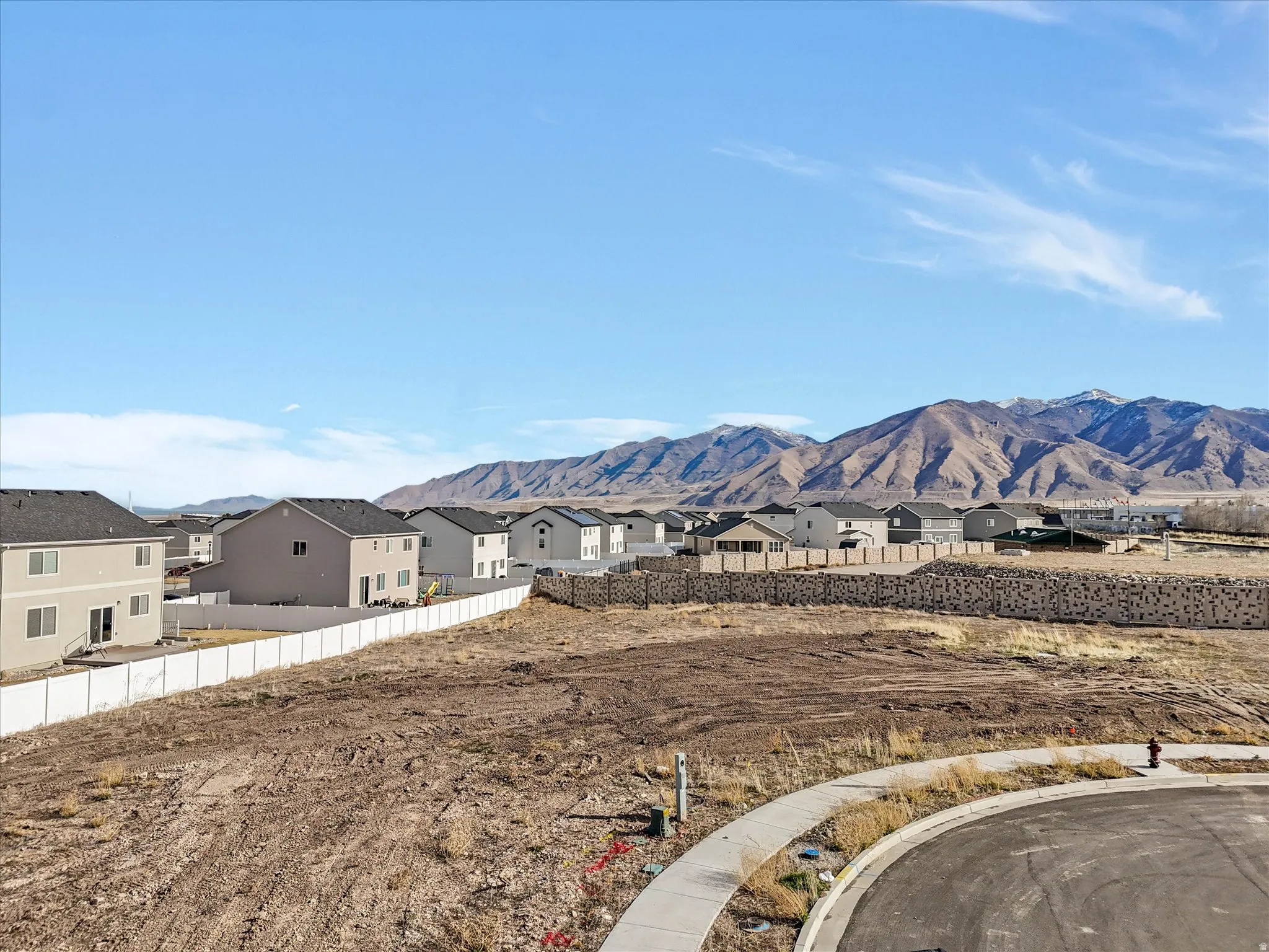 View of mountain backdrop featuring nearby suburban area
