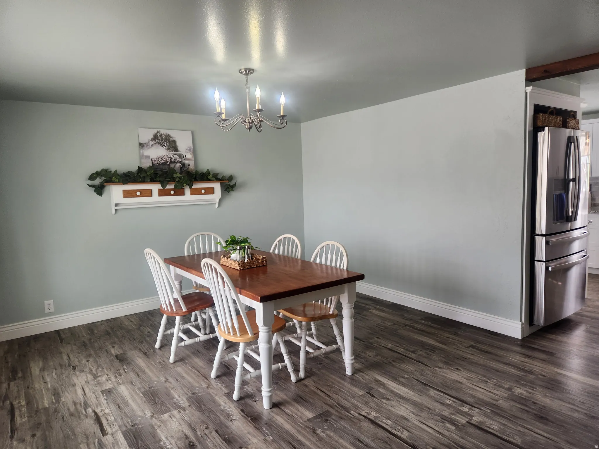 Dining space featuring dark wood-type flooring and hanging lights