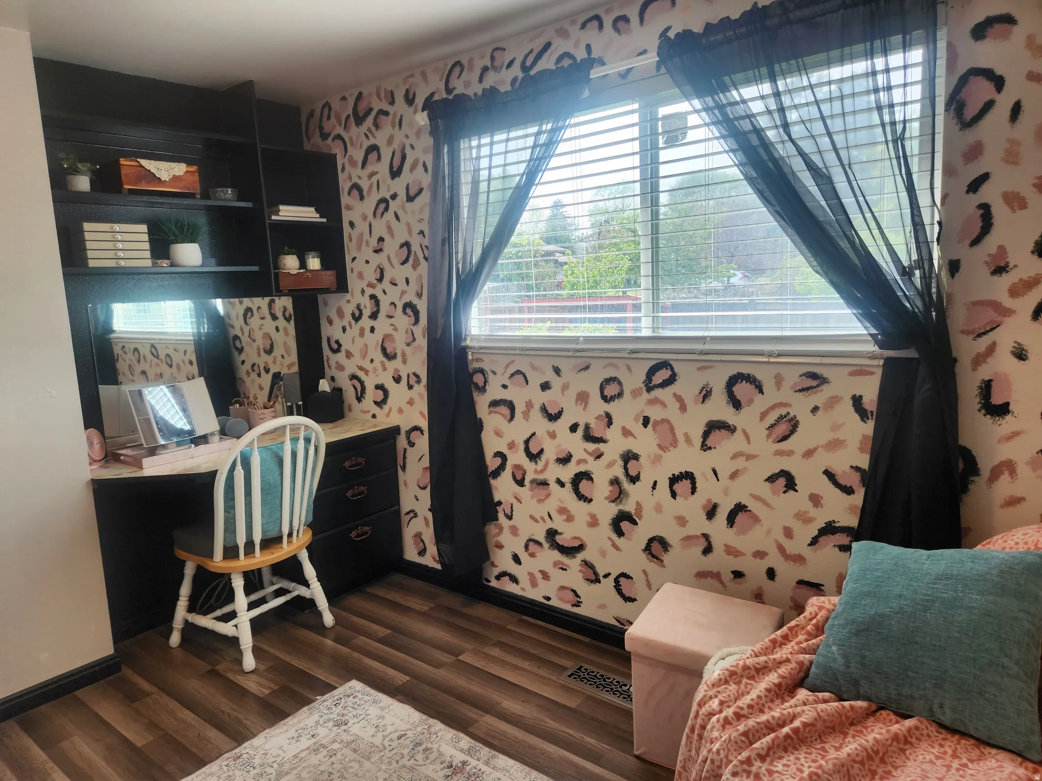 Office space with built in study area, dark wood-type flooring, and wallpapered walls