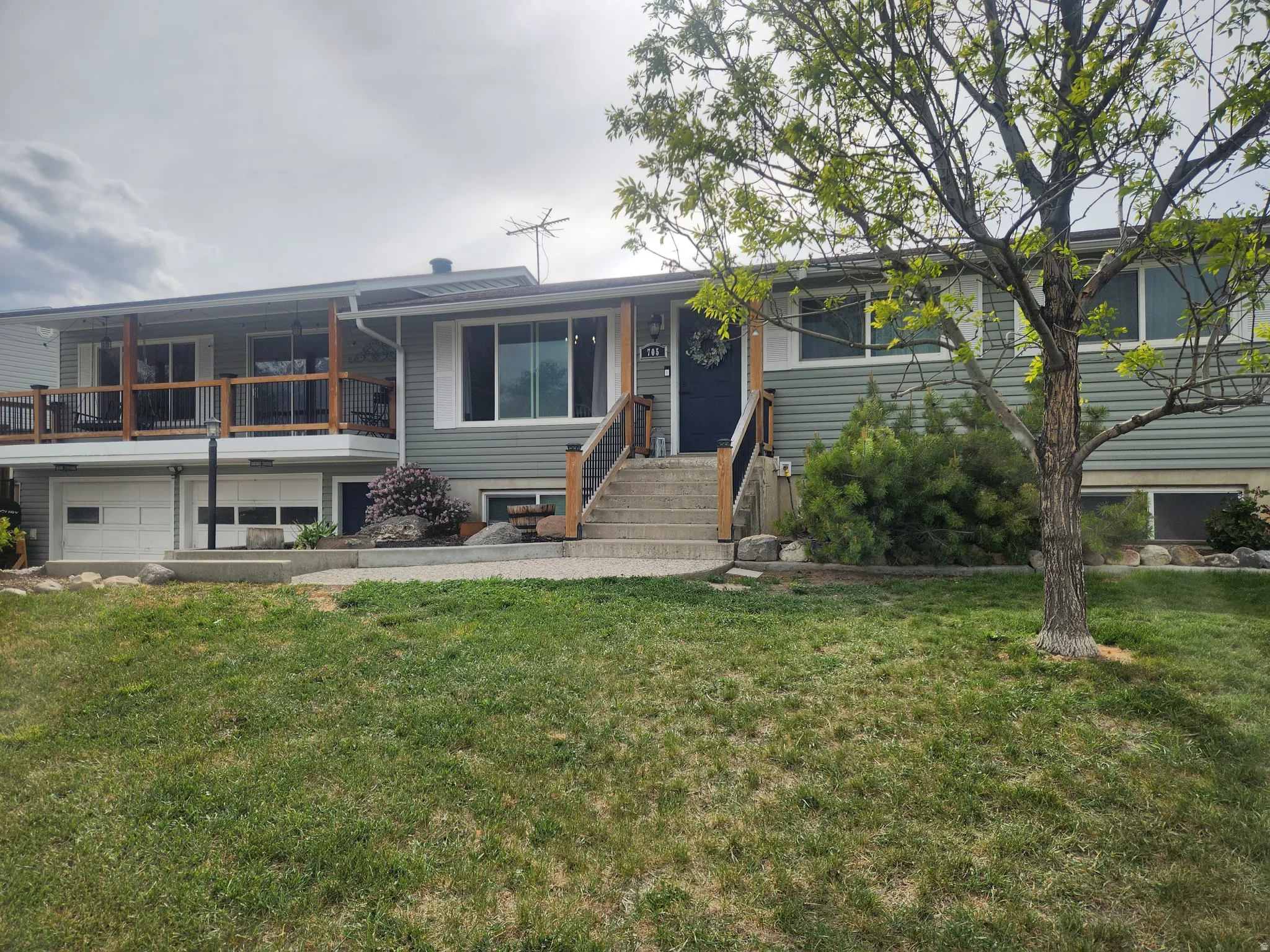 View of front facade with an attached garage and a front lawn