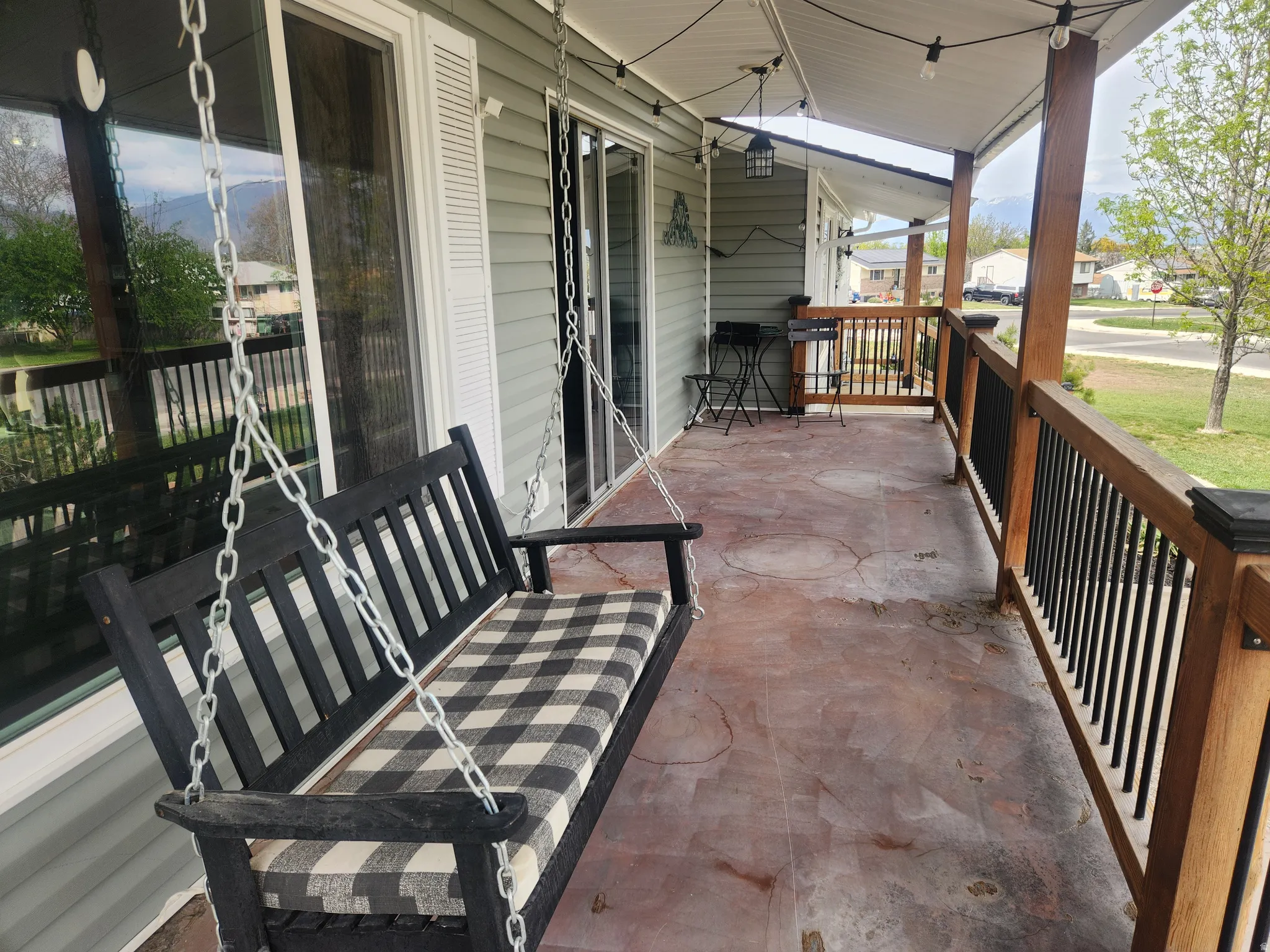 Covered porch featuring a residential view