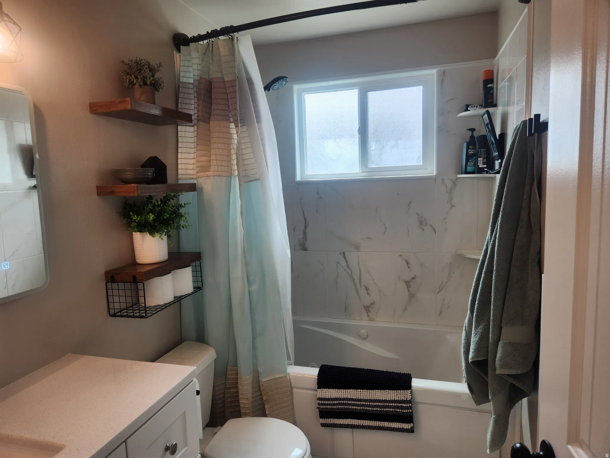 Bathroom with vanity and shower / bath combination with curtain