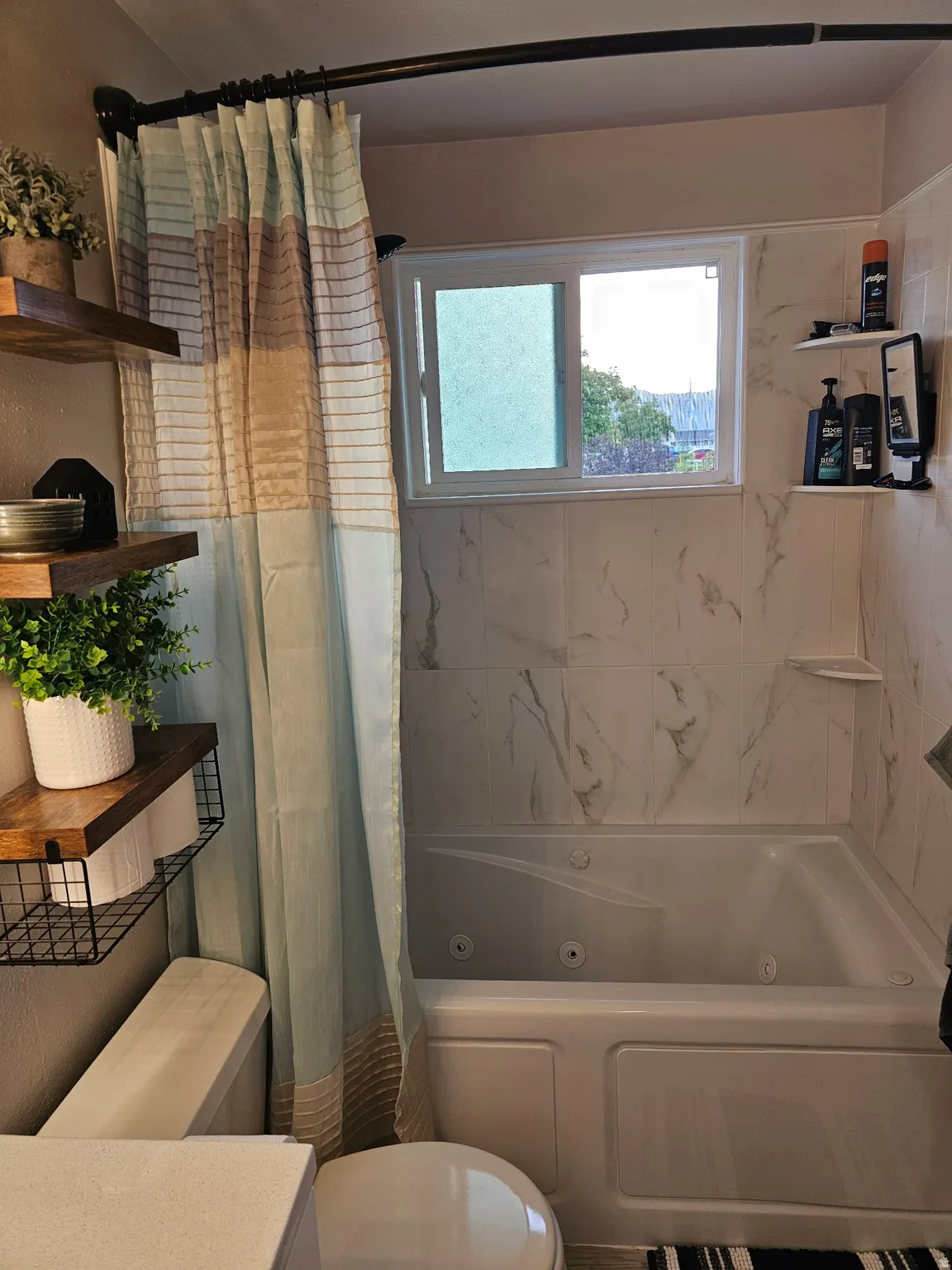 Full bathroom featuring a combined bath / shower with jetted tub, plenty of natural light, and vanity