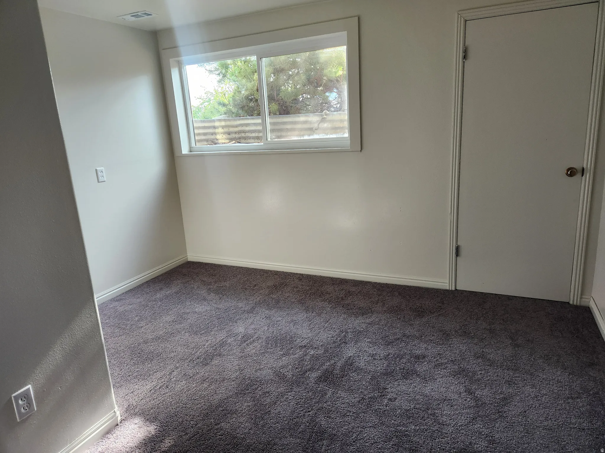 Unfurnished bedroom featuring baseboards and carpet flooring