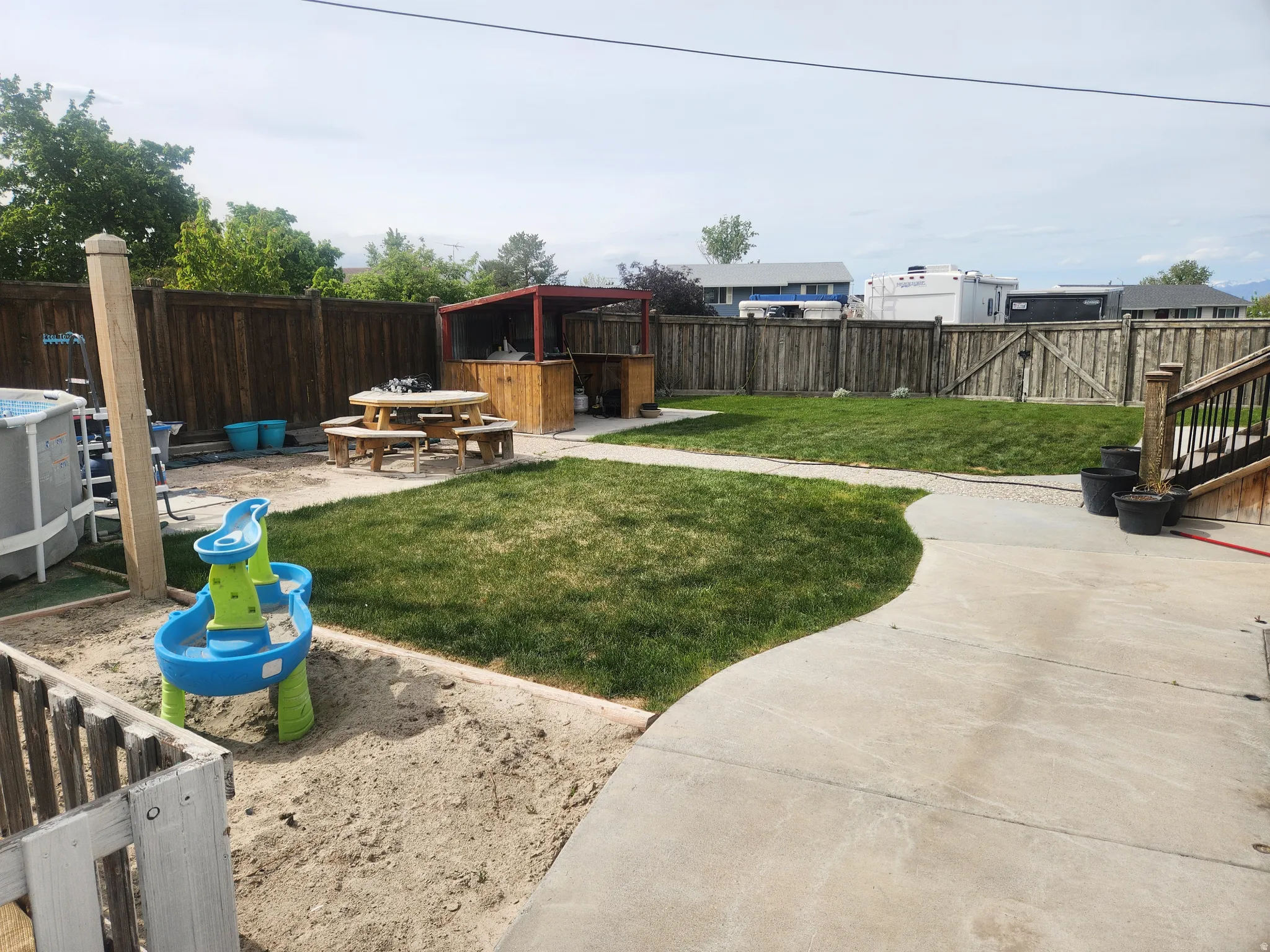 Fenced backyard with a patio area