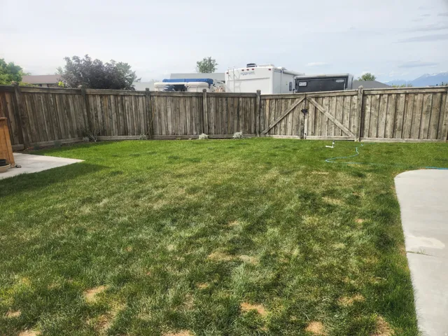 Fenced backyard with a gate