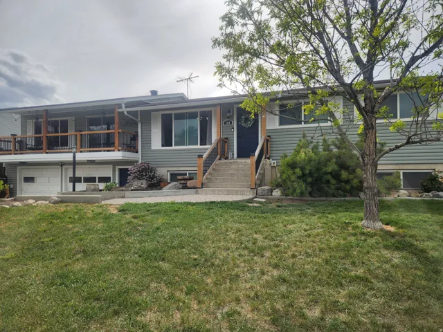 View of front facade with an attached garage and a front lawn