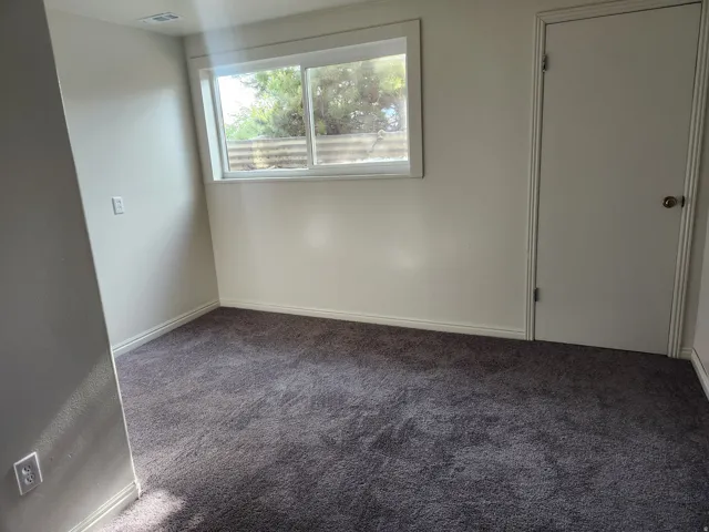 Unfurnished bedroom featuring baseboards and carpet flooring