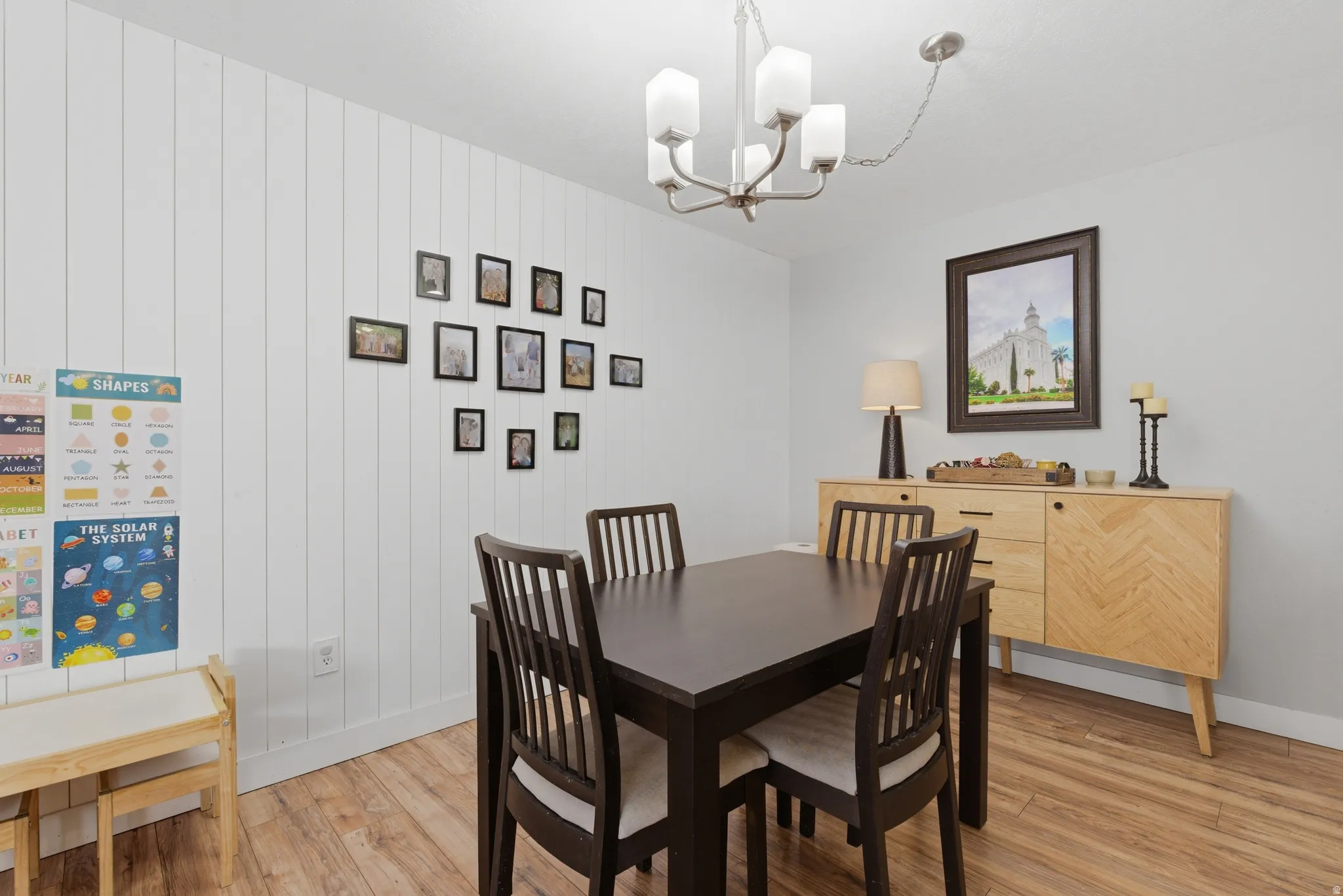 Dining space featuring light wood-style floors and suspended lighting