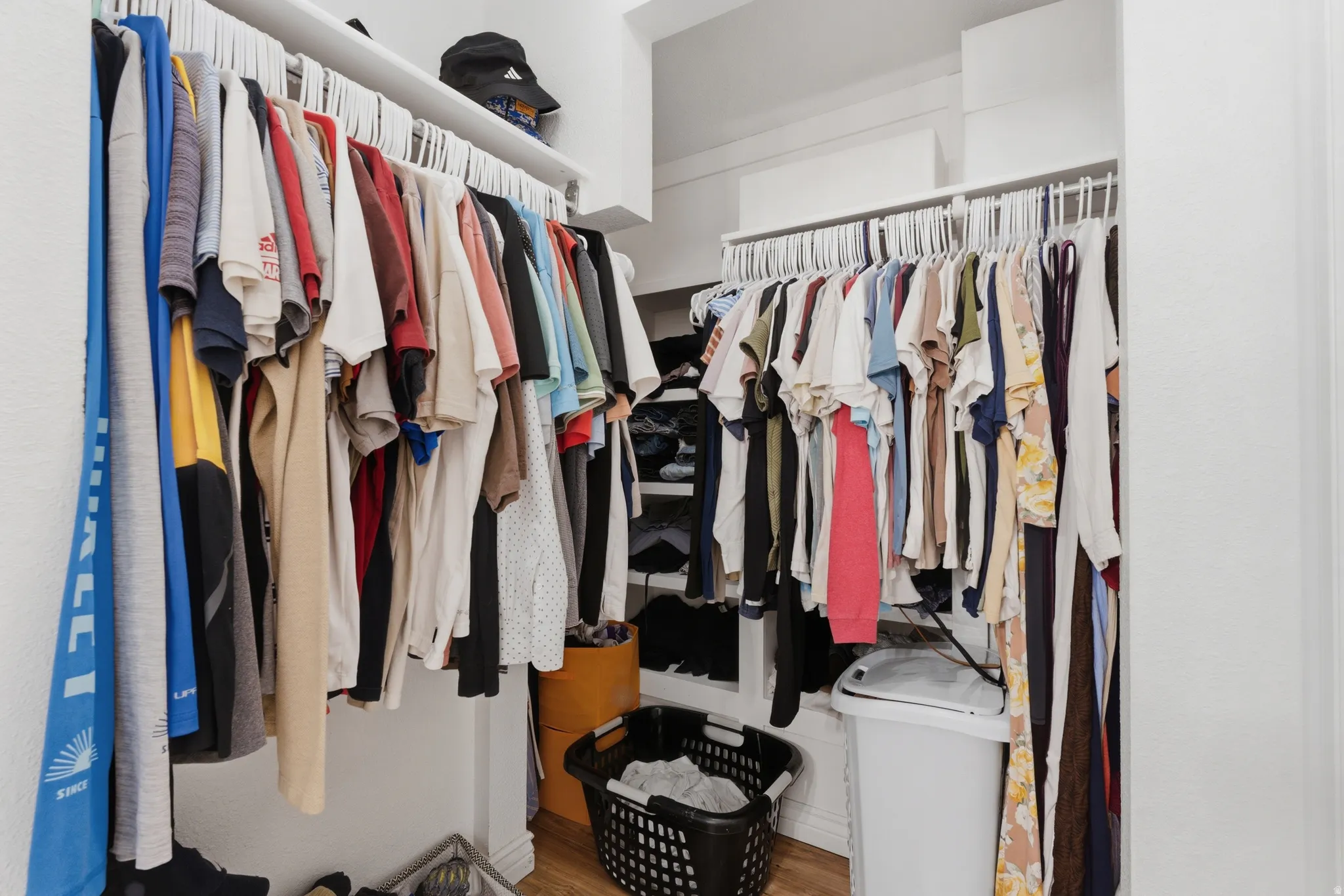 Walk in closet with light wood-type flooring