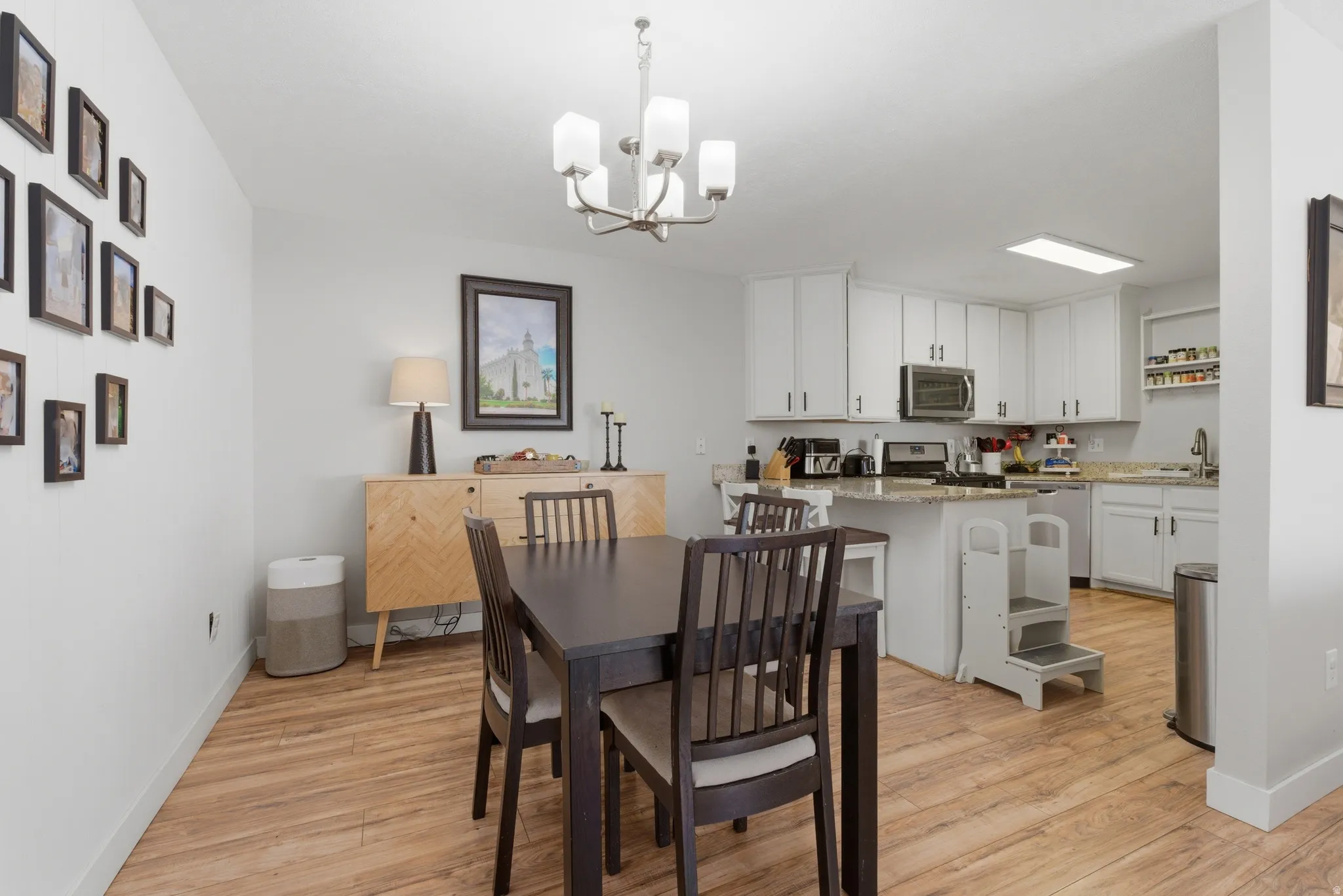 Dining room featuring suspended lighting and light wood-style flooring