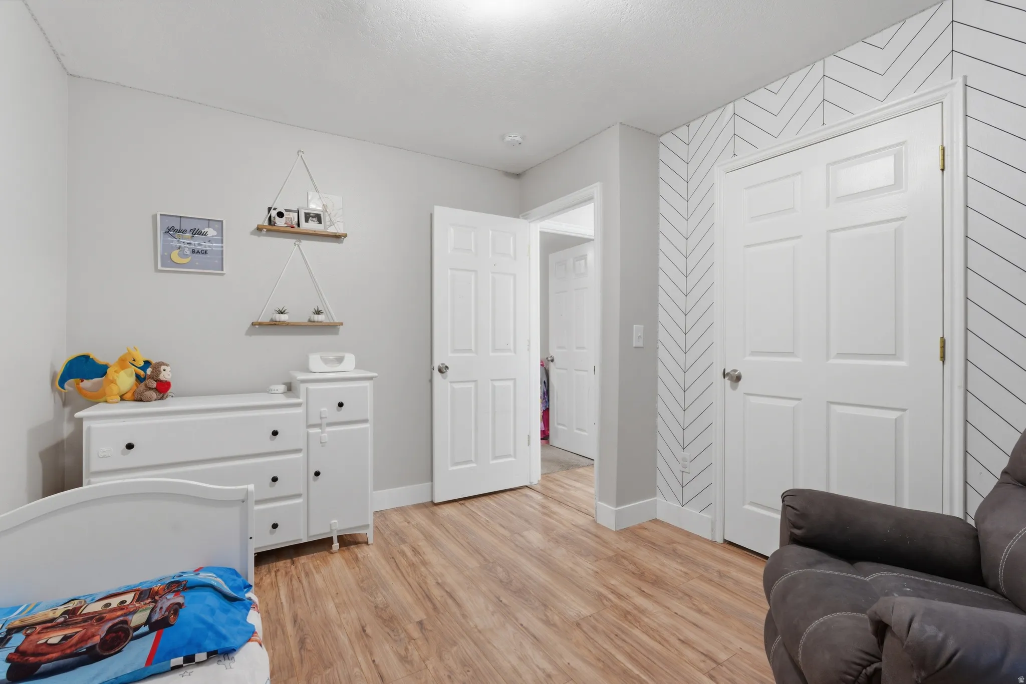 Bedroom with light wood-style flooring and baseboards