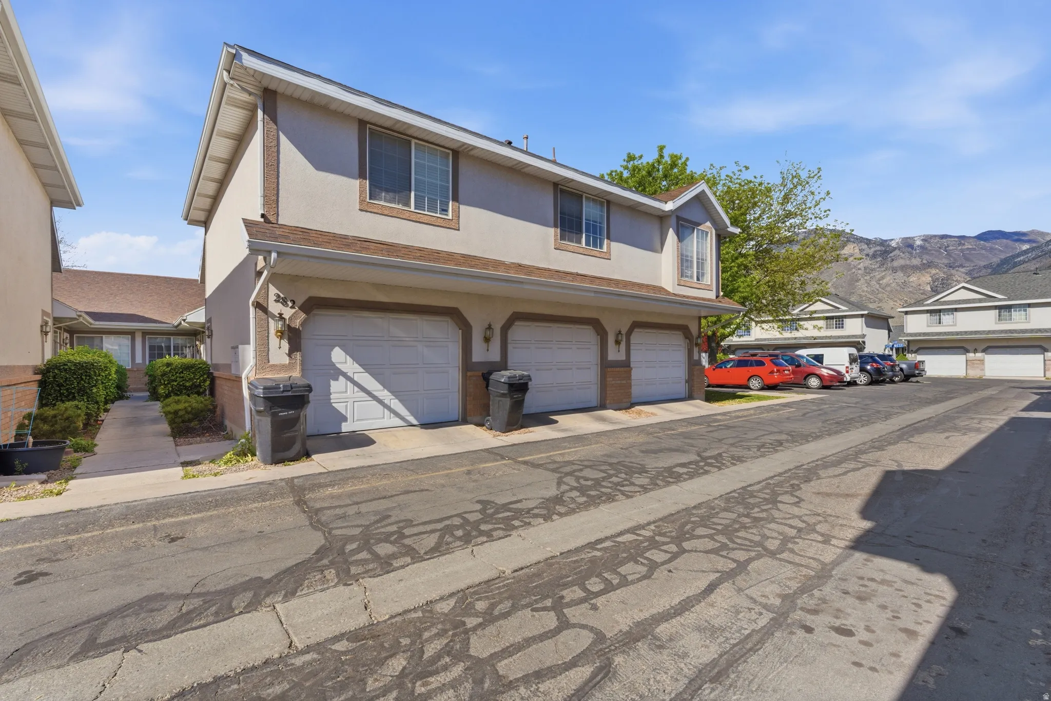 Traditional-style house with stucco siding, a mountain view, a residential view, and brick siding