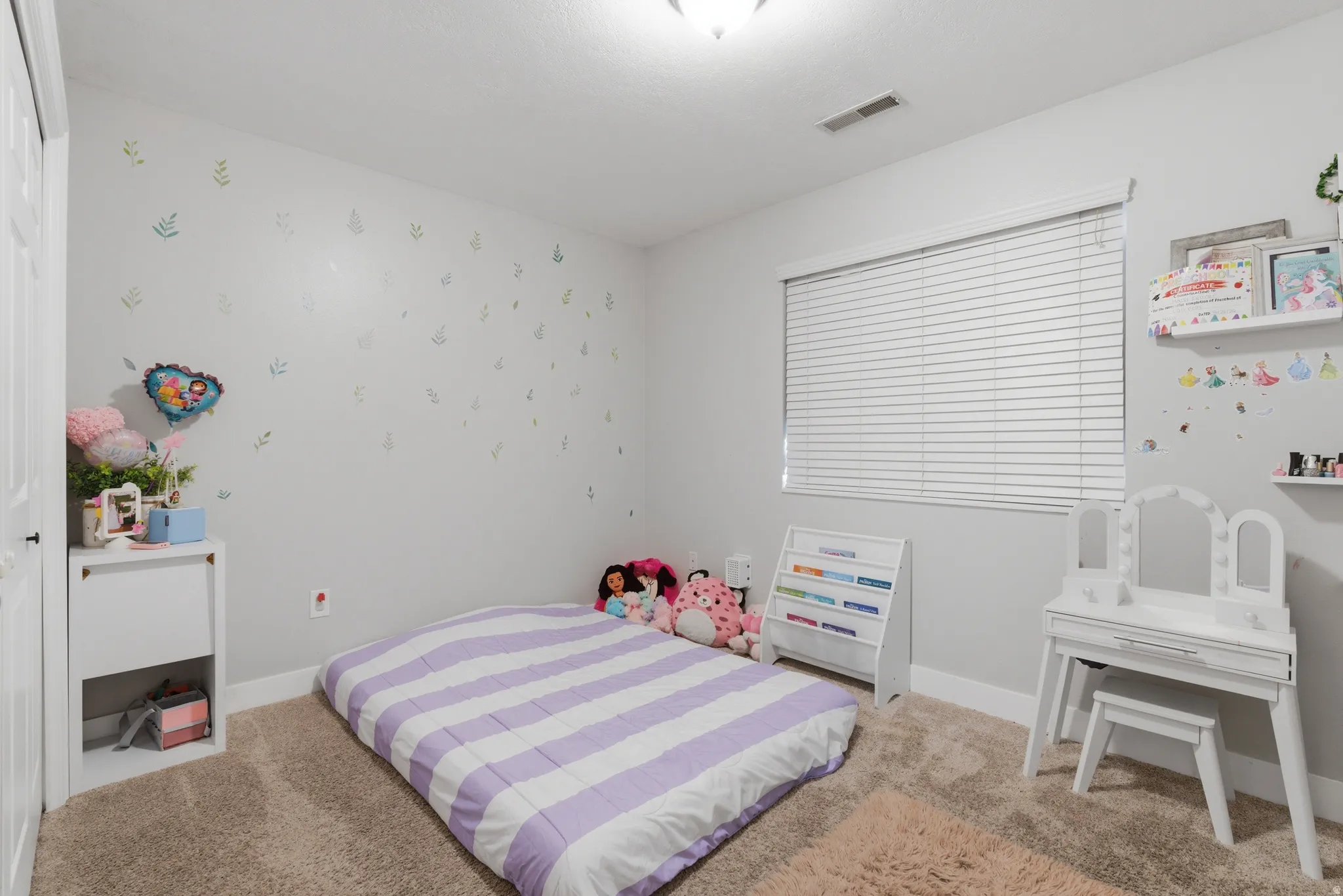 Bedroom featuring light colored carpet and wallpapered walls