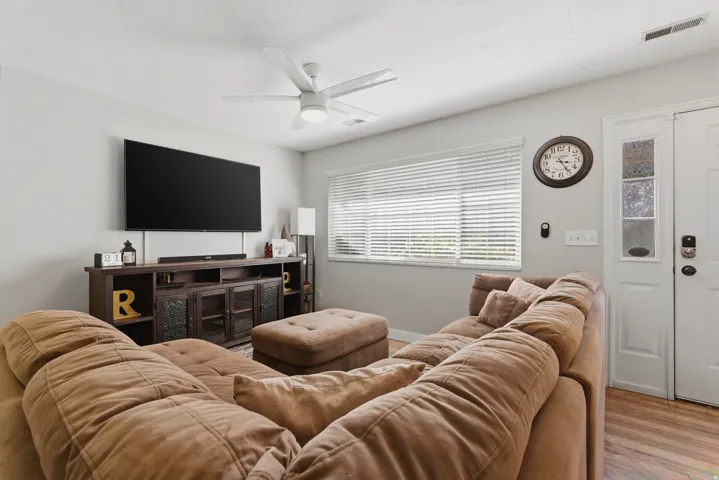 Living room with wood finished floors and ceiling fan