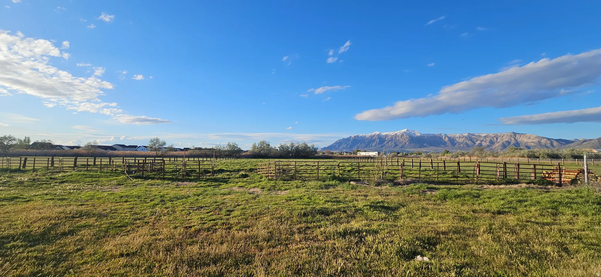 View of yard featuring a mountain view and an enclosed horse arena