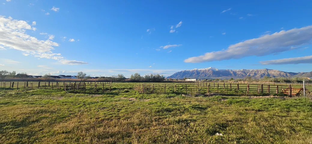 View of yard featuring a mountain view and an enclosed horse arena