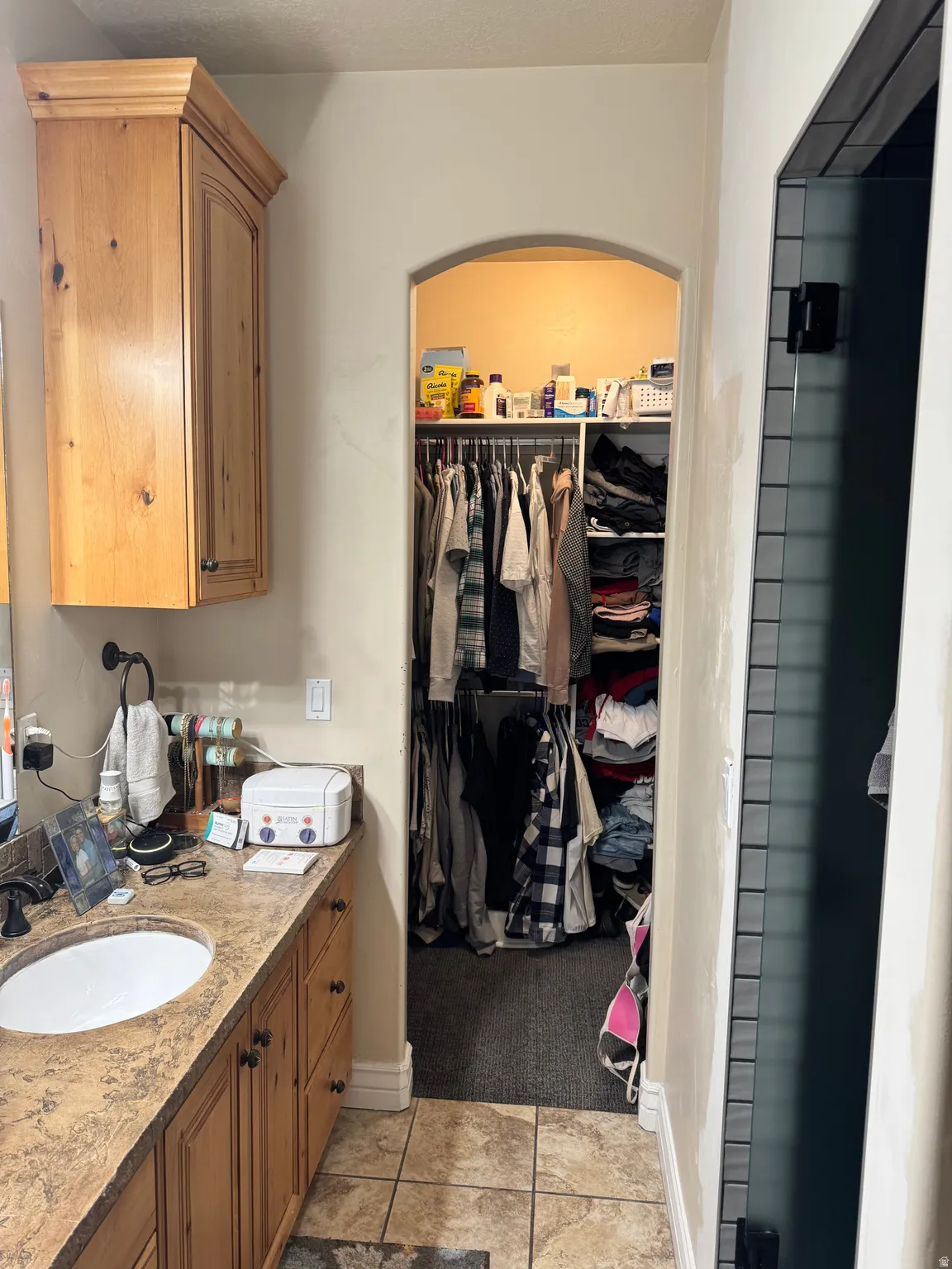 Full bath with vanity and a walk in closet