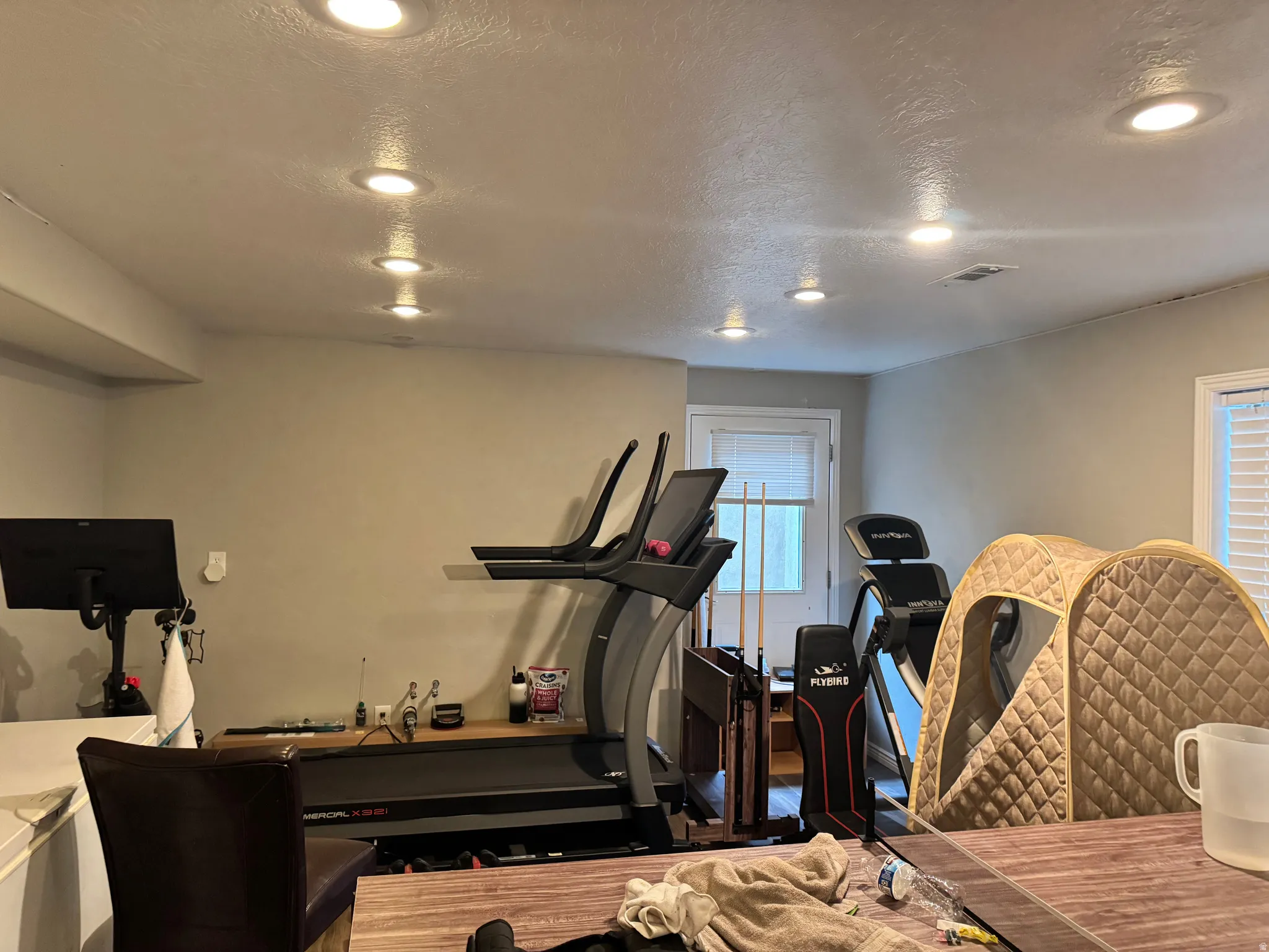 Workout area featuring a textured ceiling and recessed lighting