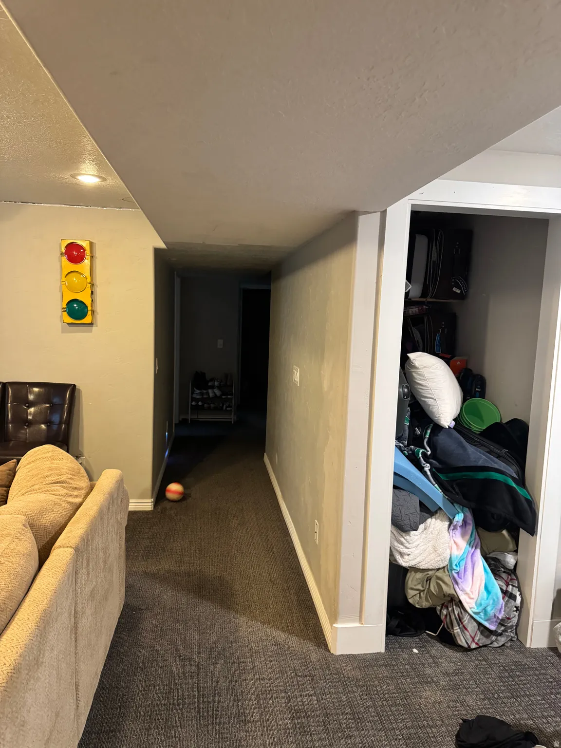 Corridor with dark carpet and a textured ceiling