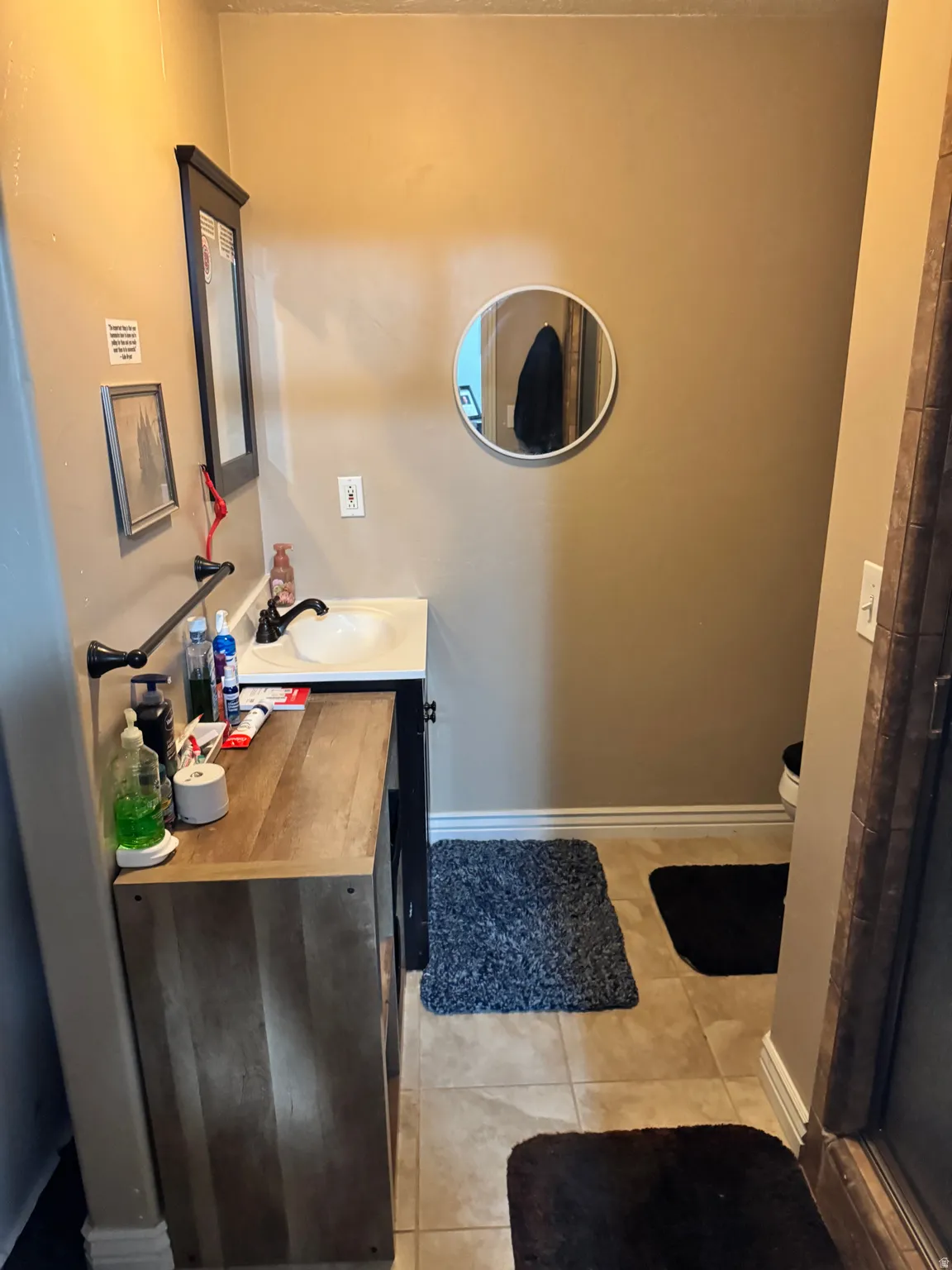 Full bath featuring vanity and light tile patterned flooring