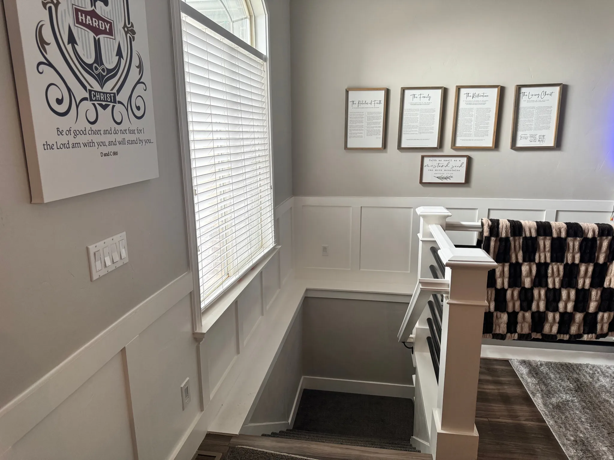 Stairway with a decorative wall and a wainscoted wall
