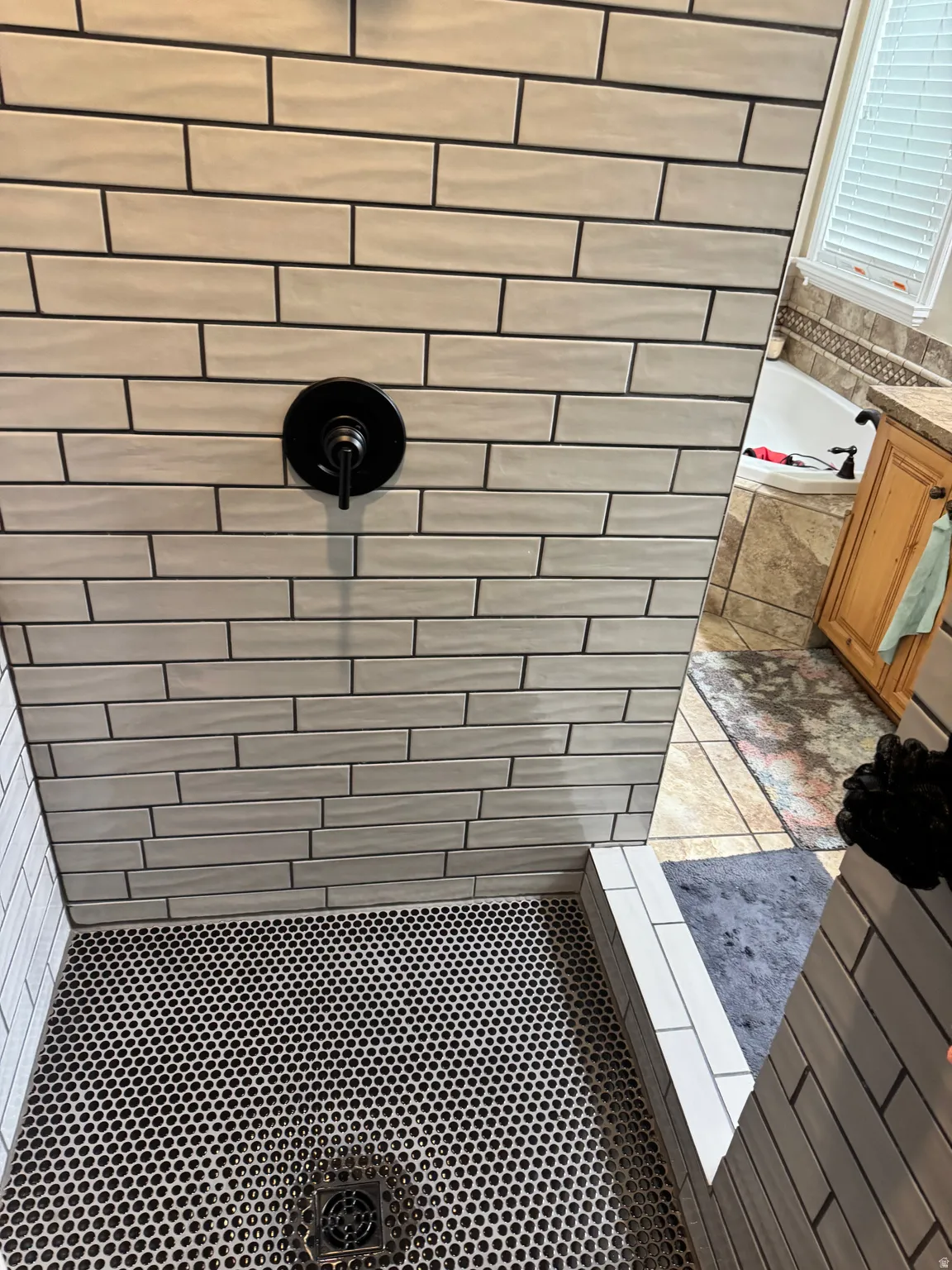 Bathroom with tile patterned flooring, a tile shower, and a bath