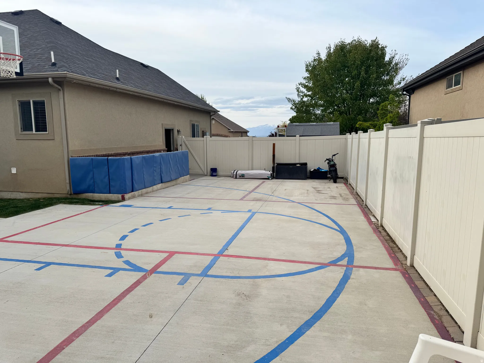 View of basketball court featuring a fenced backyard