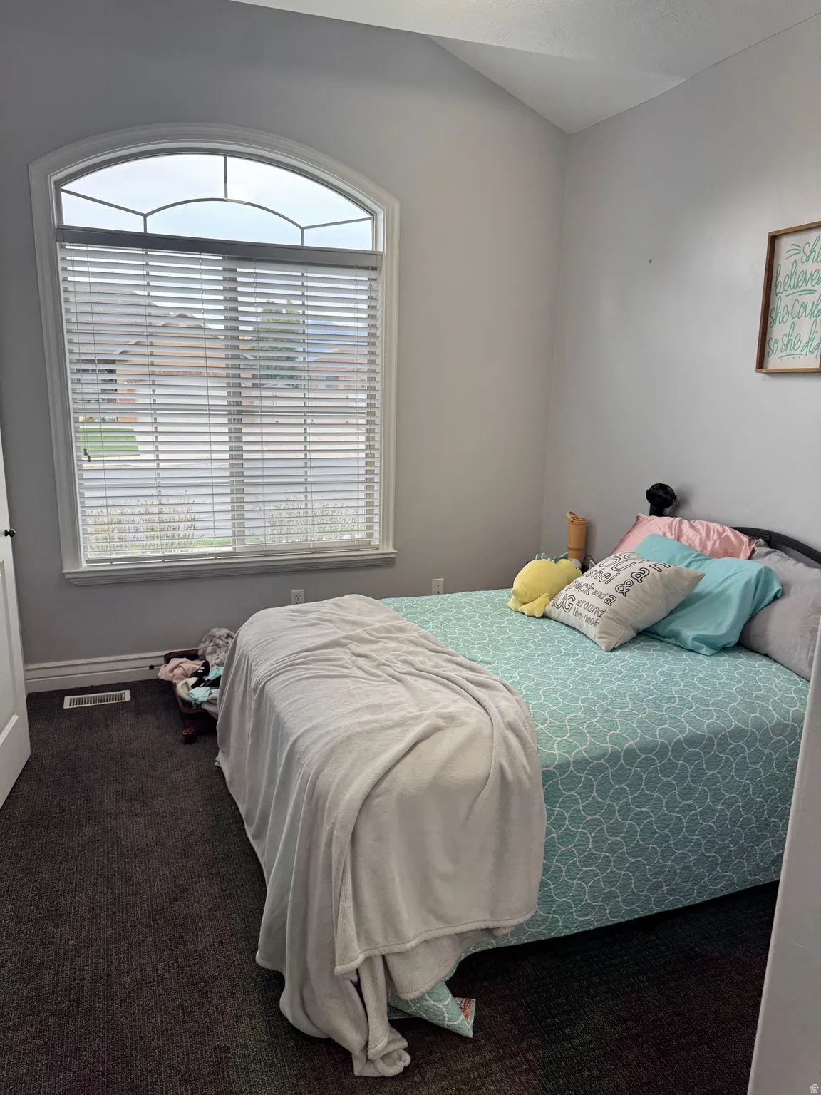 Bedroom with dark colored carpet