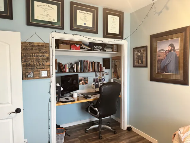 Office space featuring dark wood-style floors and baseboards