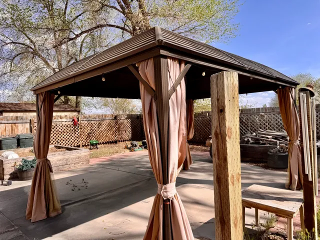 Fenced backyard with a gazebo and a patio