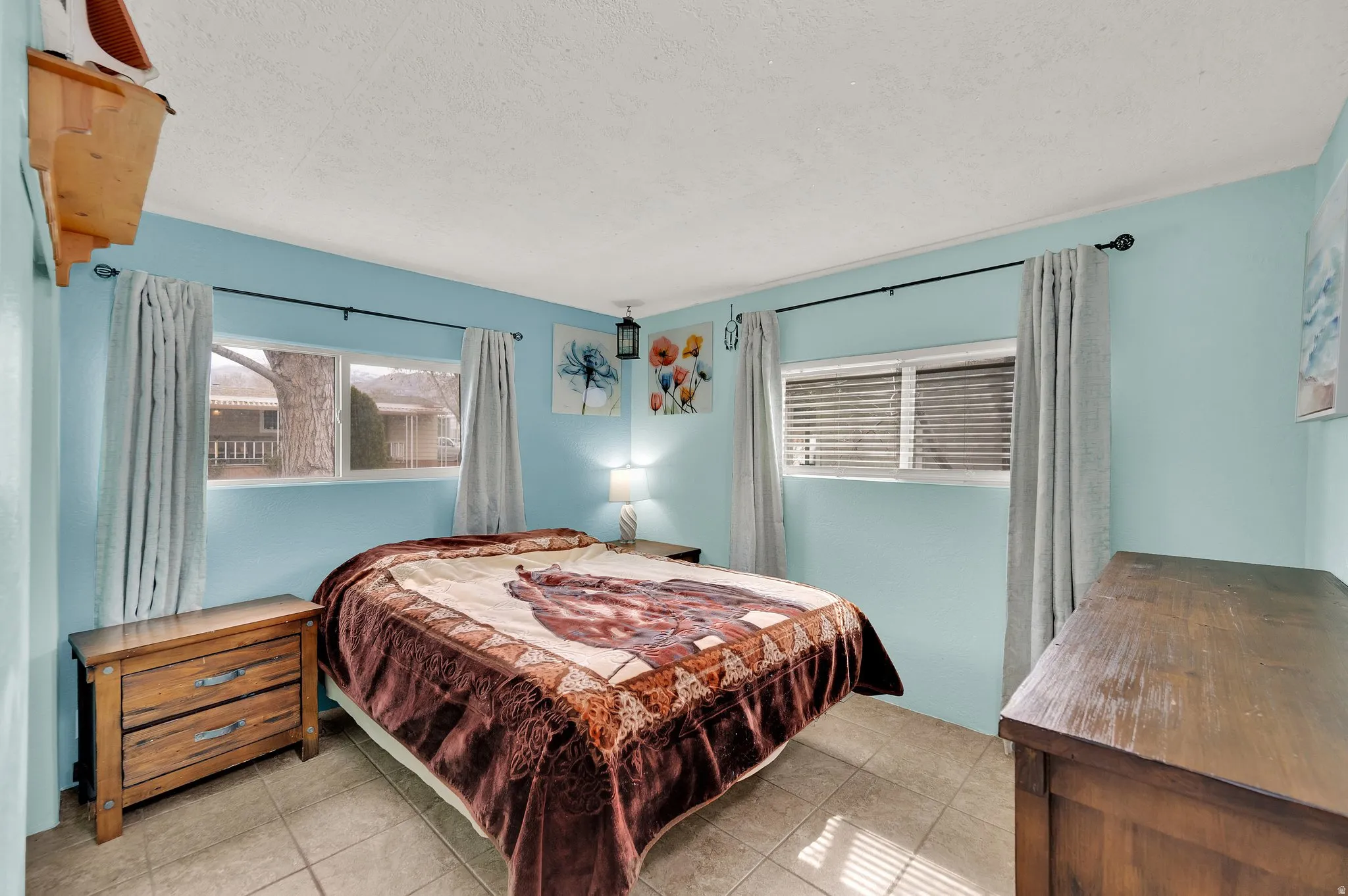 Bedroom featuring light tile patterned flooring and a textured ceiling