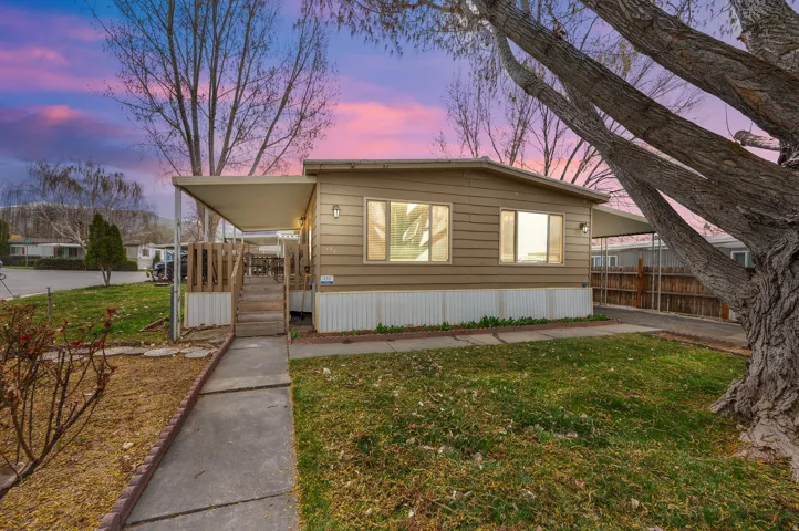 Manufactured / mobile home featuring a porch and a carport