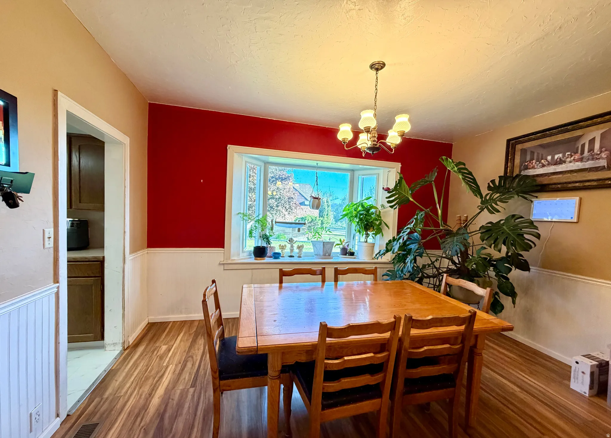 Dining area featuring wood-finish flooring and a bay window