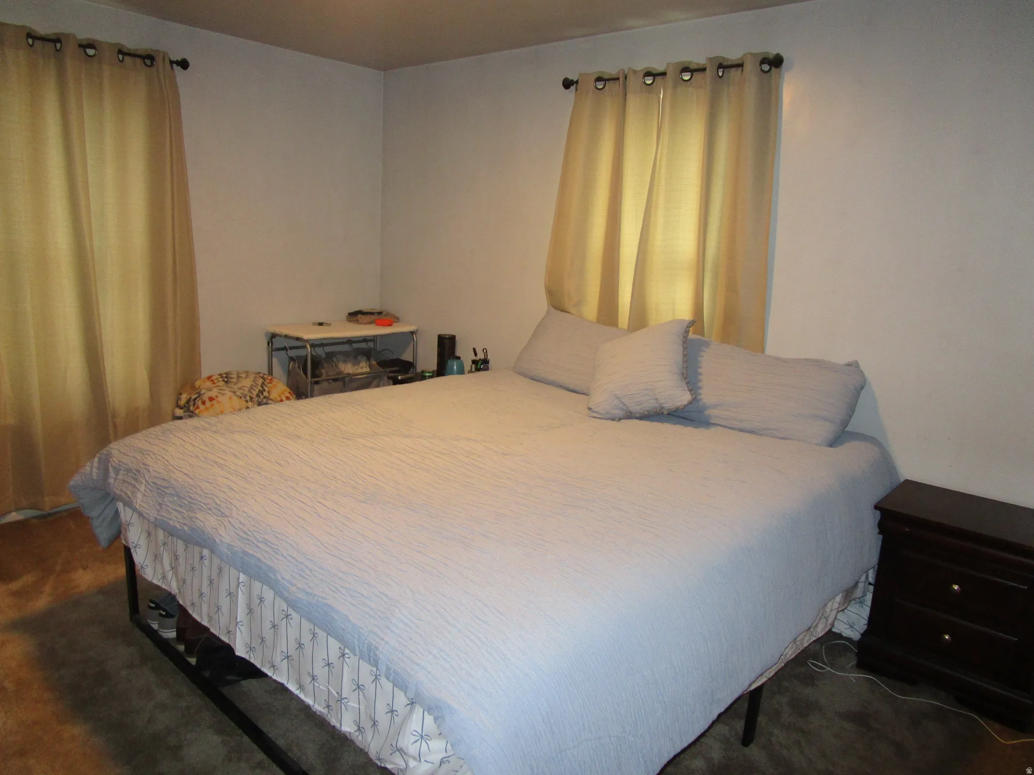Bedroom featuring dark colored carpet