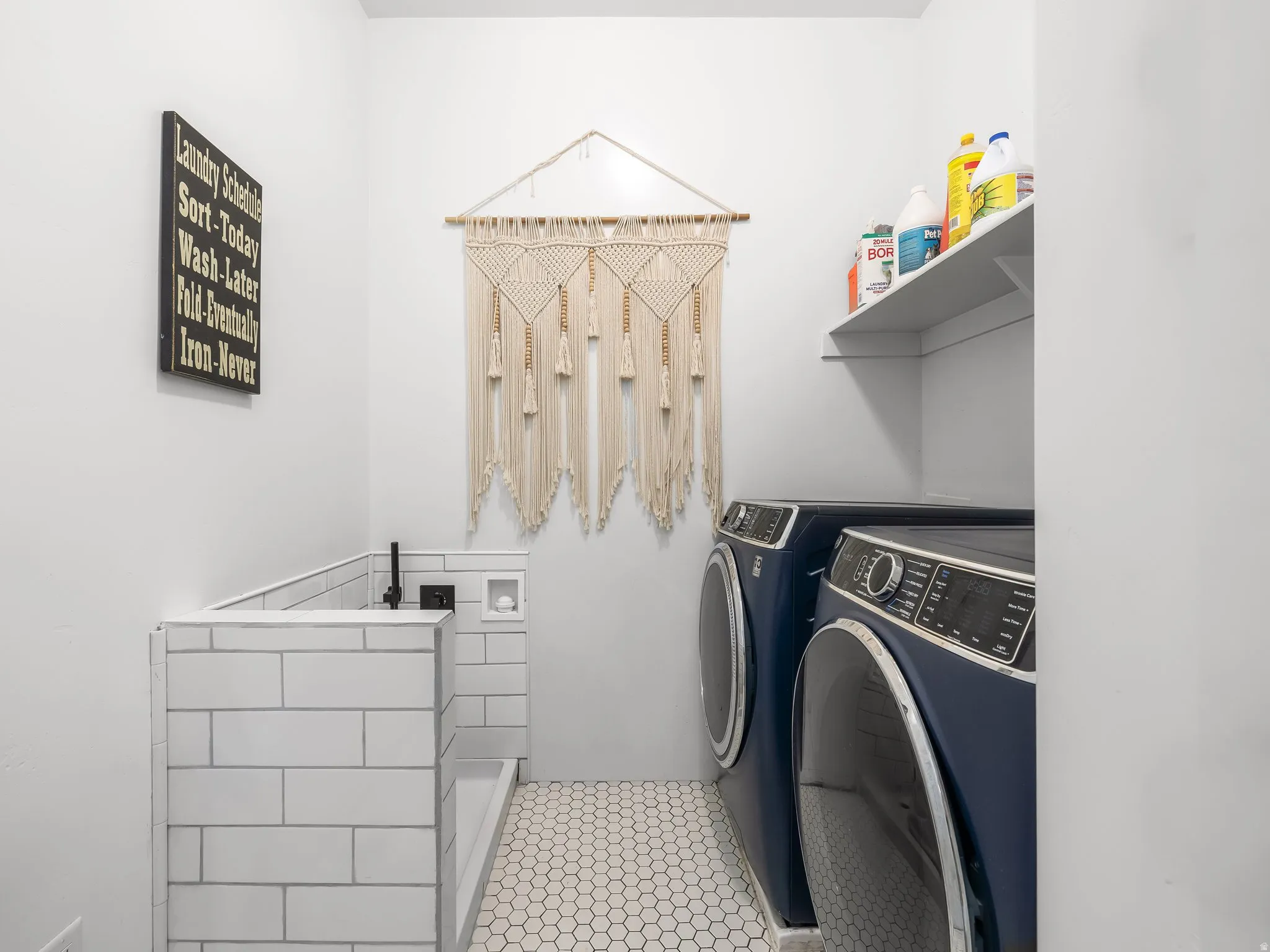 Laundry room featuring independent washer and dryer and light tile patterned flooring