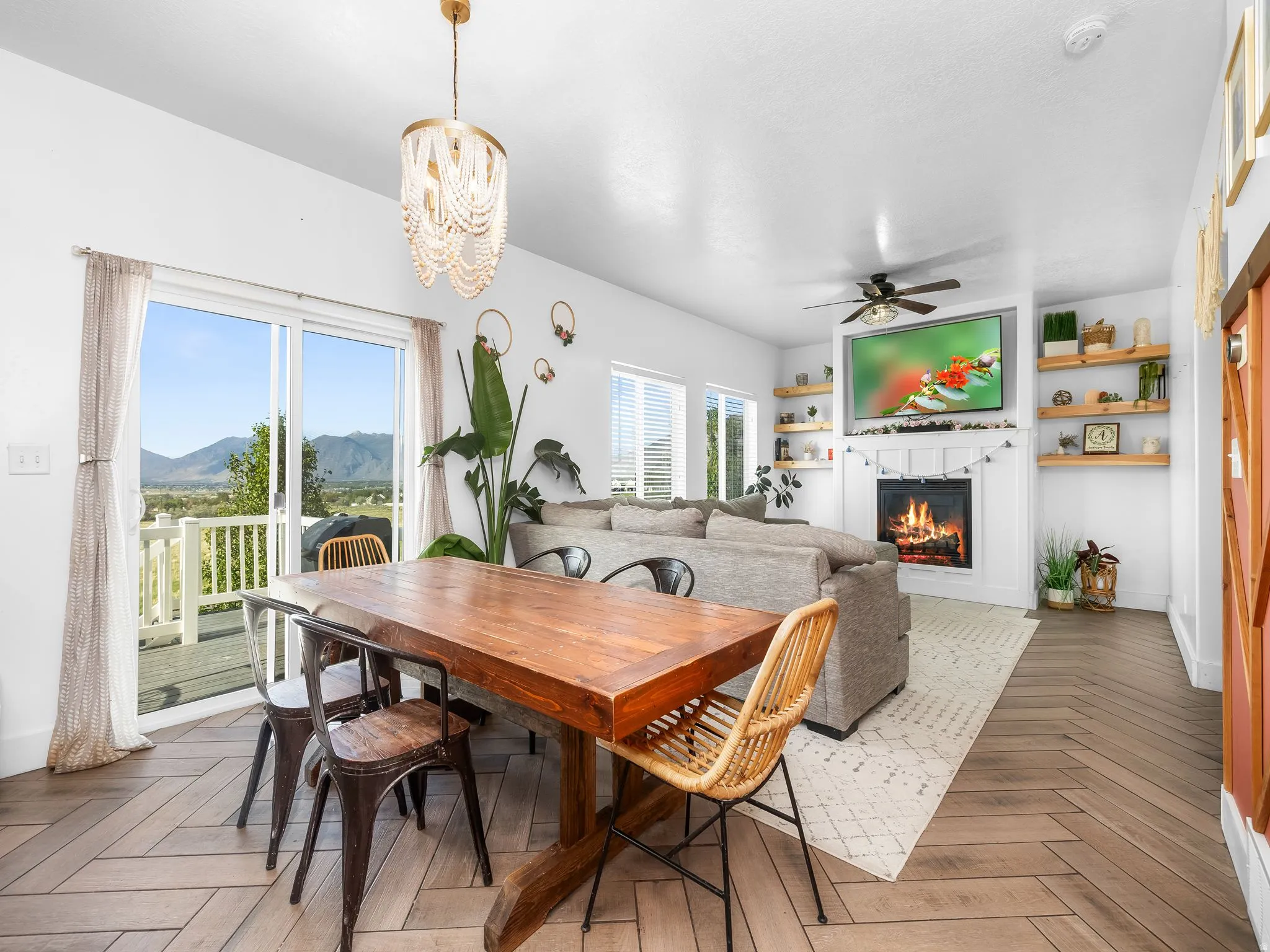 Dining area featuring parquet floors, hanging lights, ceiling fan, and plenty of natural light